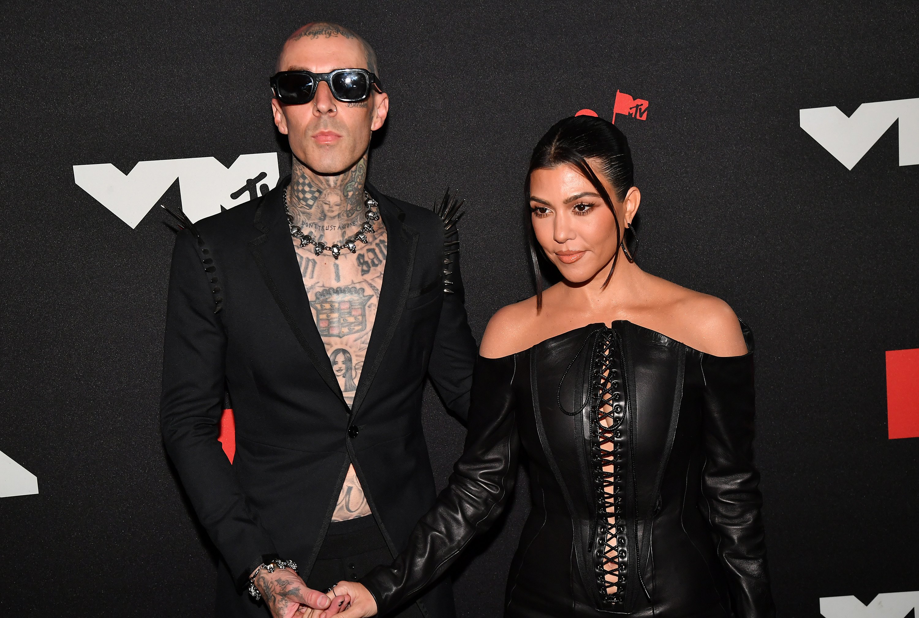 Travis Barker and Kourtney Kardashian holding hands on the red carpet at the 2021 MTV Video Music Awards