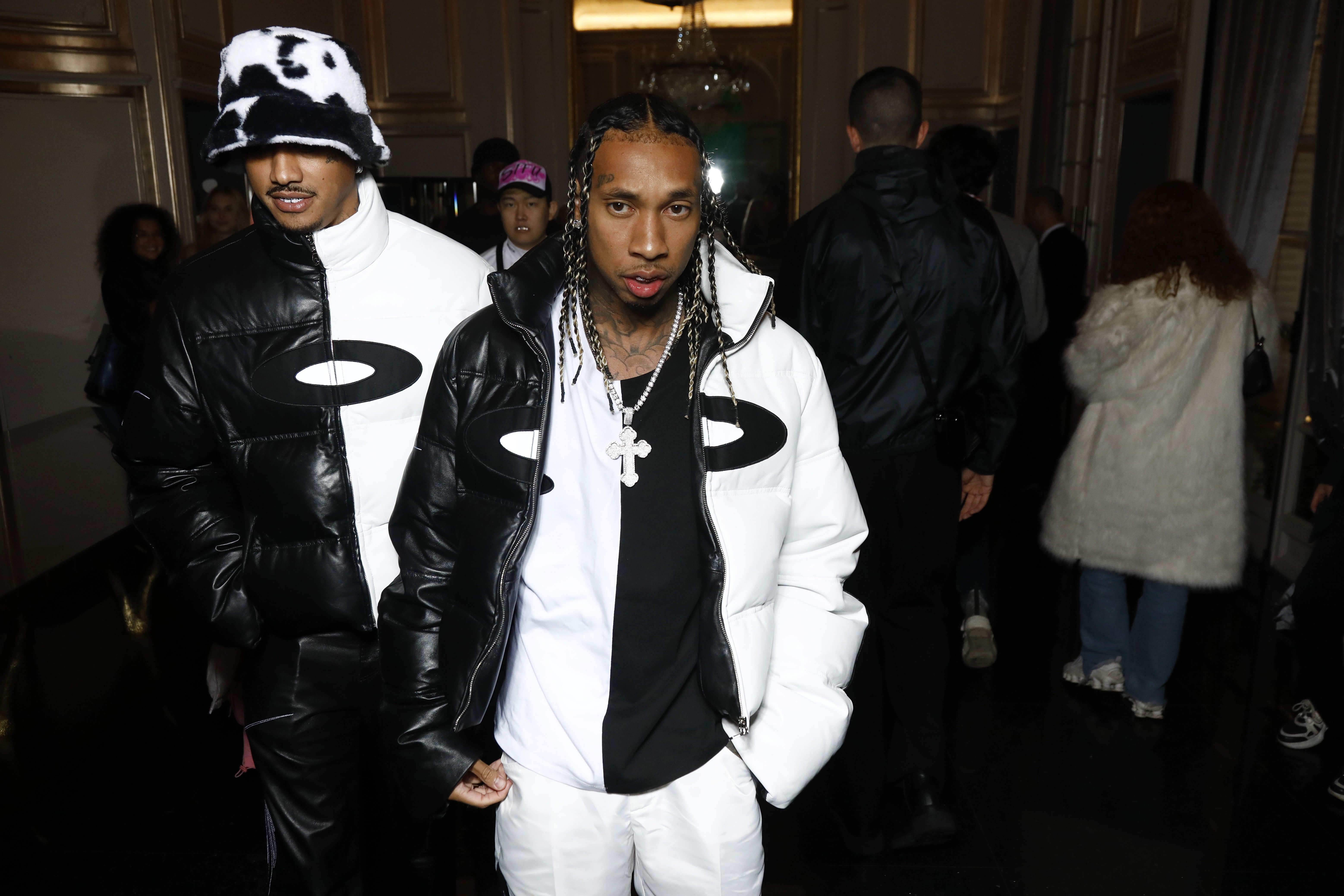 Tyga wearing a black and white jacket over a black and white shirt.