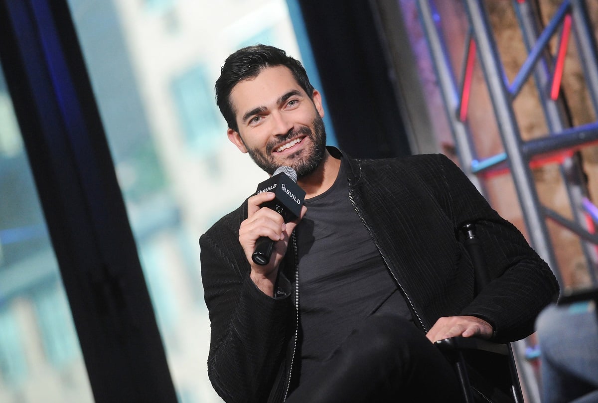 Tyler Hoechlin holding a microphone