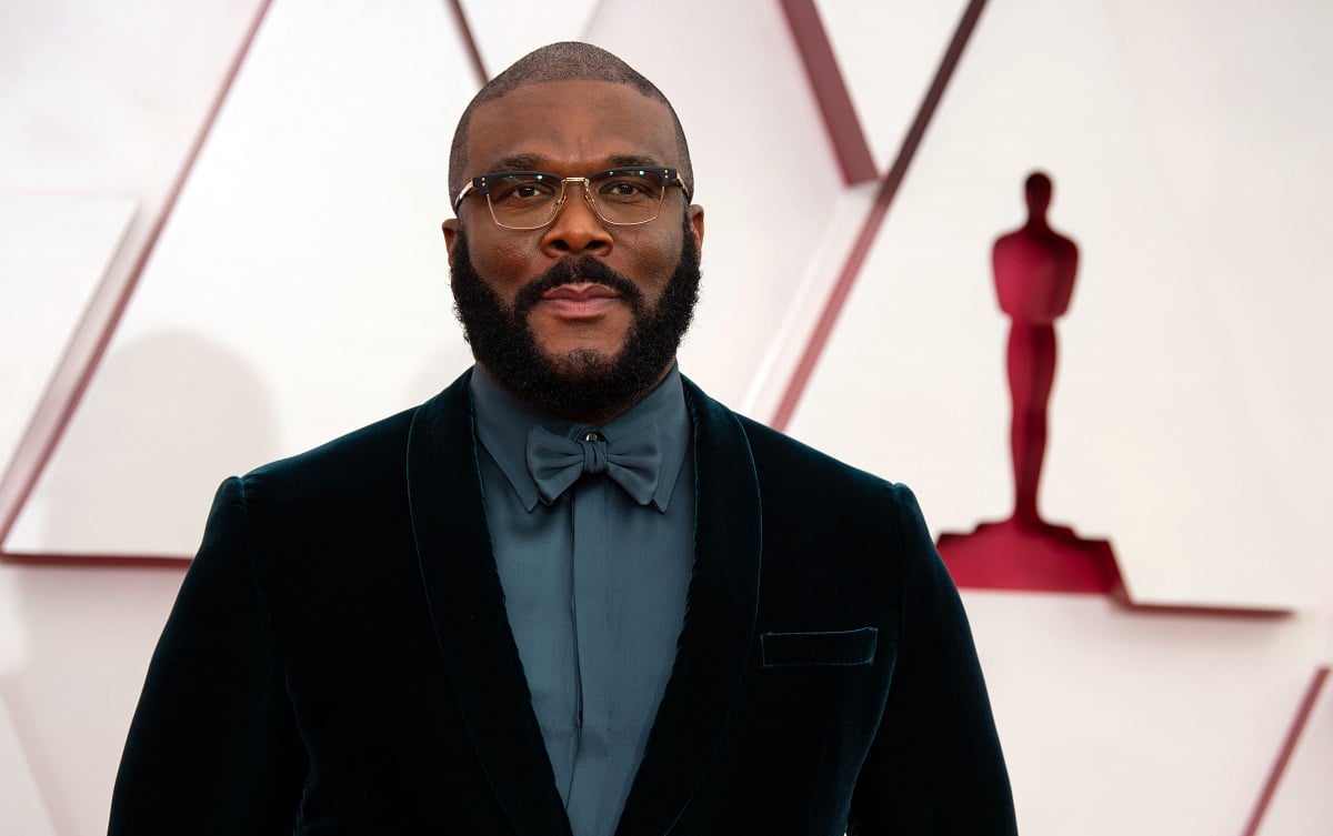 Tyler Perry smiling wearing a black suit