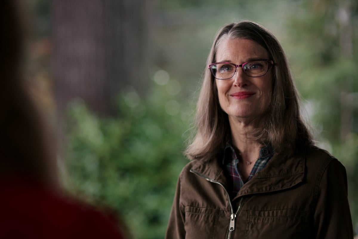 Annette O'Toole as Hope McCrea smiling with glasses on her face in 'Virgin River