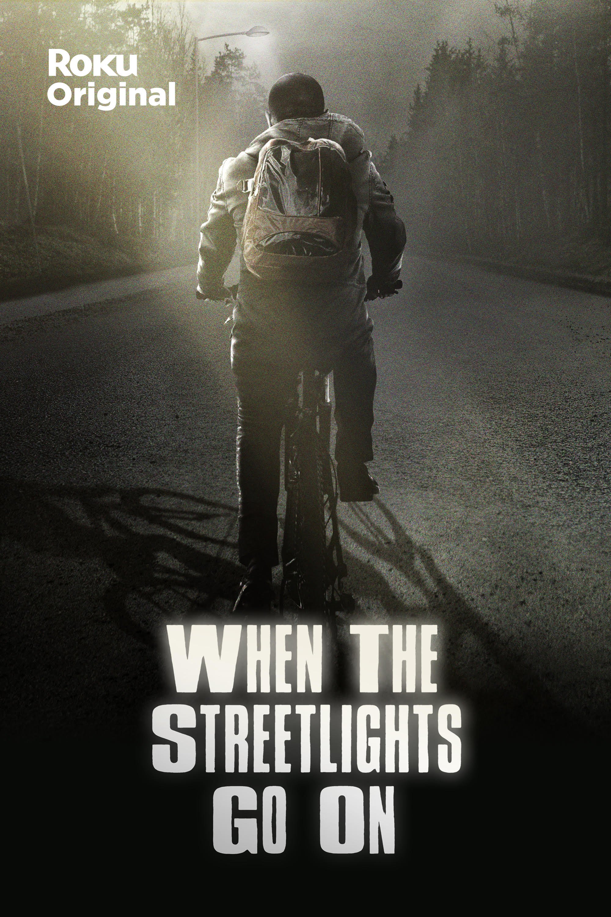 A boy rides his bike down a darkened street in the promo poster for the Roku Channel original 'When the Streetlights Go On'