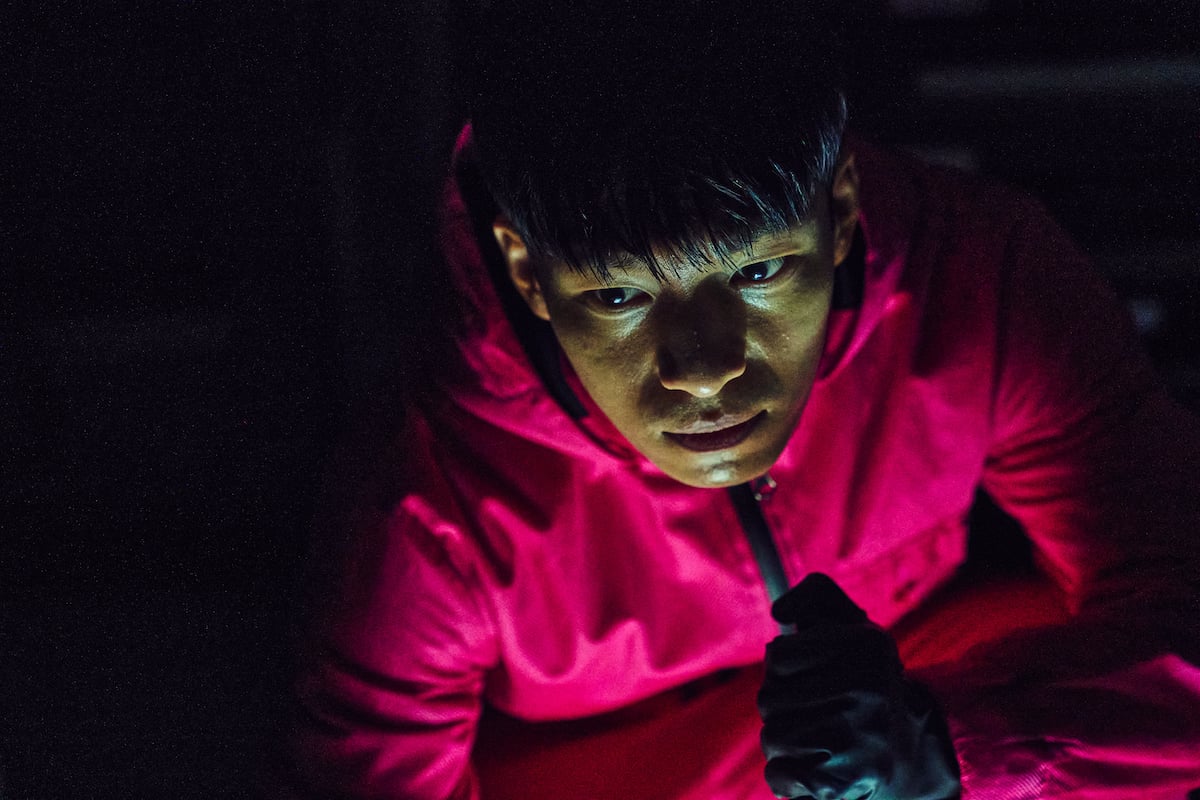 Wi Ha-jun dressed in a red jumpsuit from 'Squid Game.'