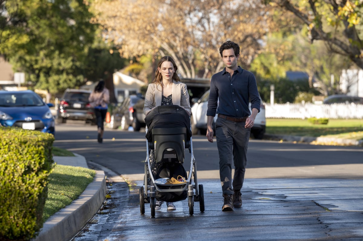 In You Season 3, Joe and Love push their baby in a stroller through the streets of Madre Linda.