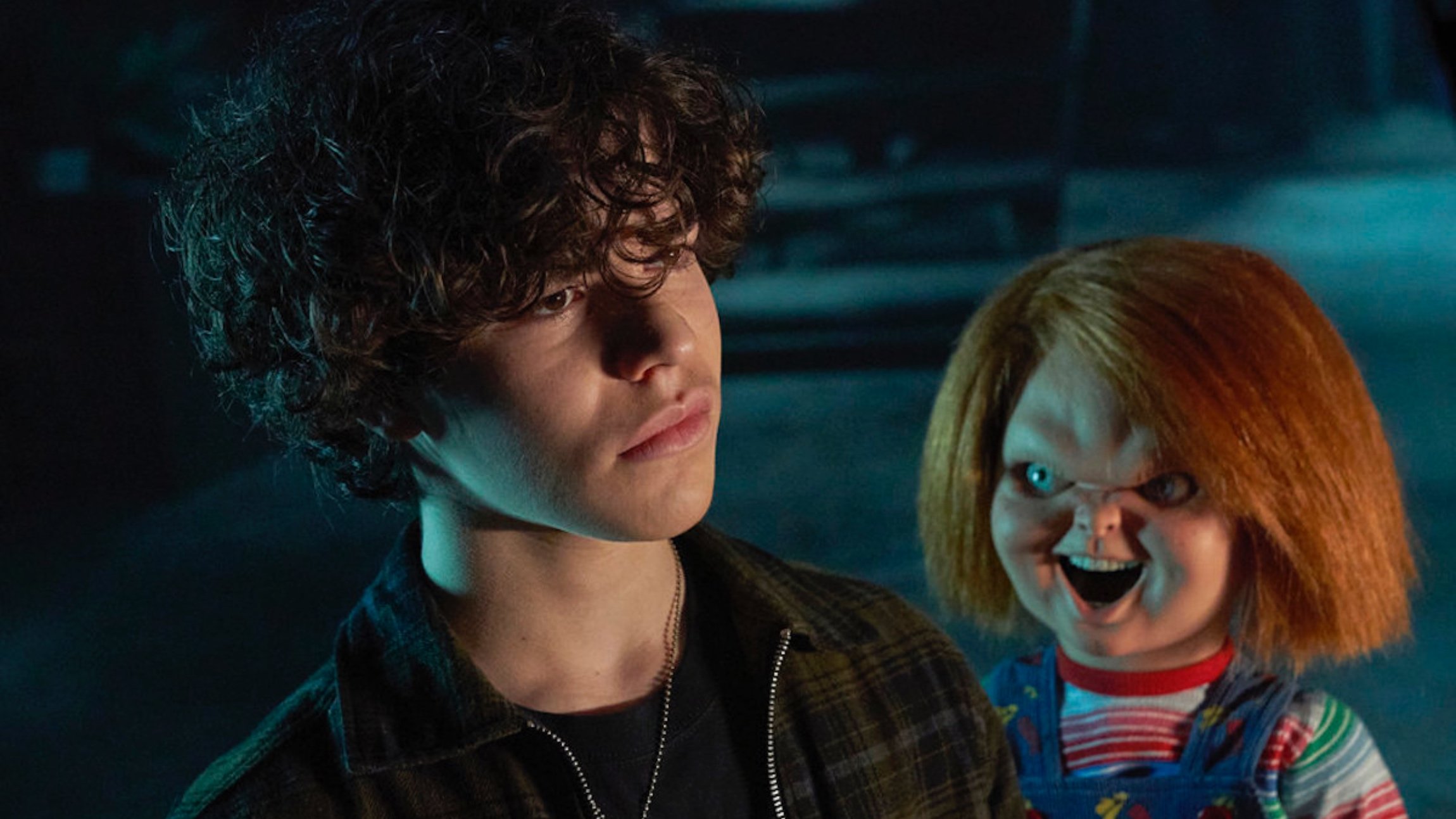 Zackary Arthur as Jake Wheeler for Don Mancini's 'Chucky' series standing next to Chucky doll