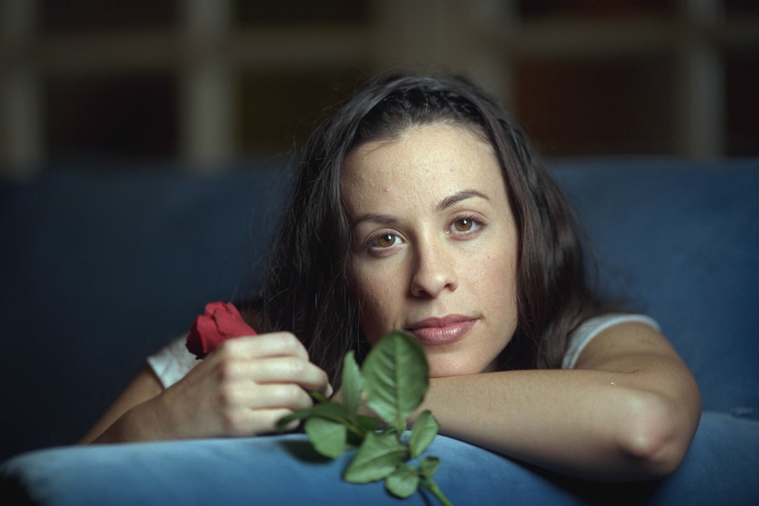 Alanis Morissette holding a rose