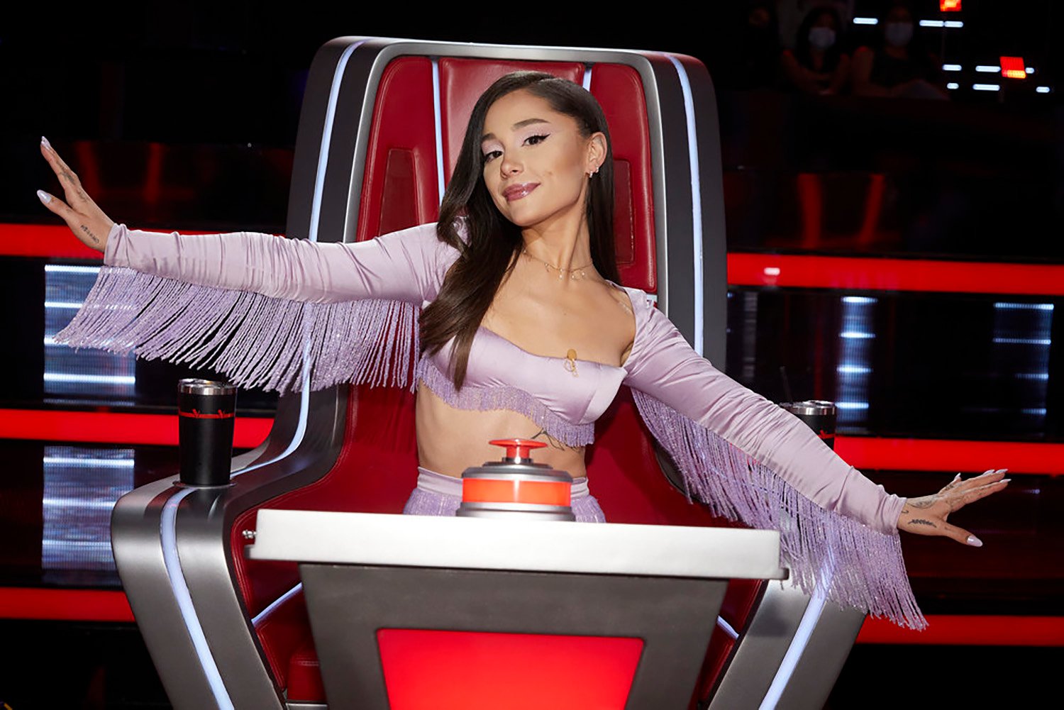 Ariana Grande sits in her chair during The Voice Season 21's Battles premiere.