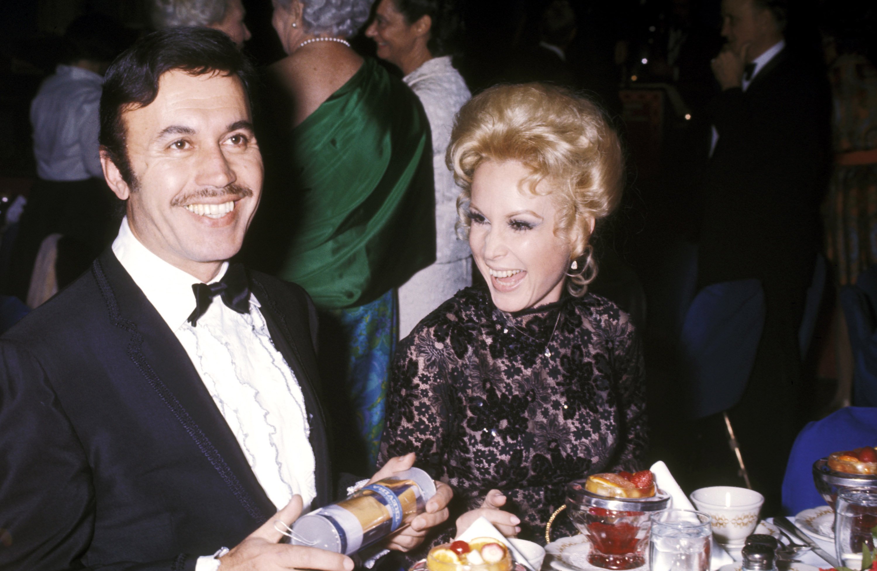 Michael Ansara and Barbara Eden sitting at a table