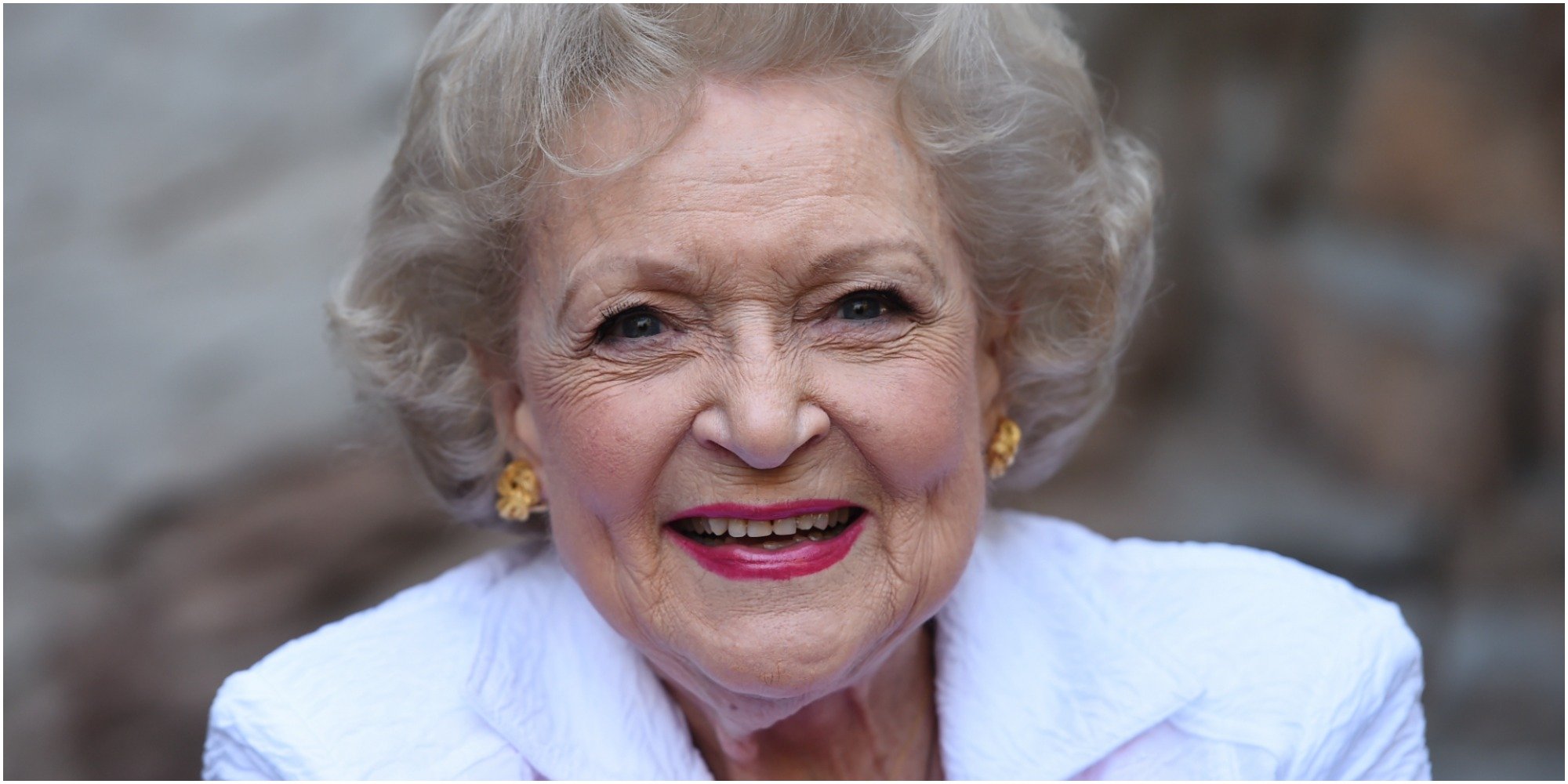 Betty White wears a jacket and blouse.