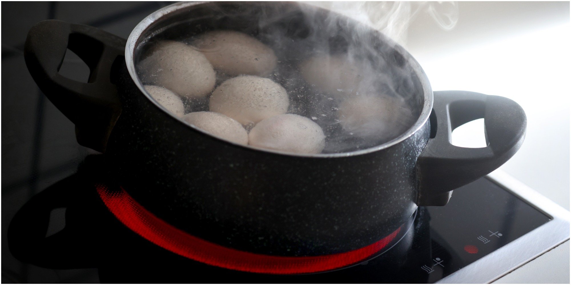 A pot with boiling water and eggs.