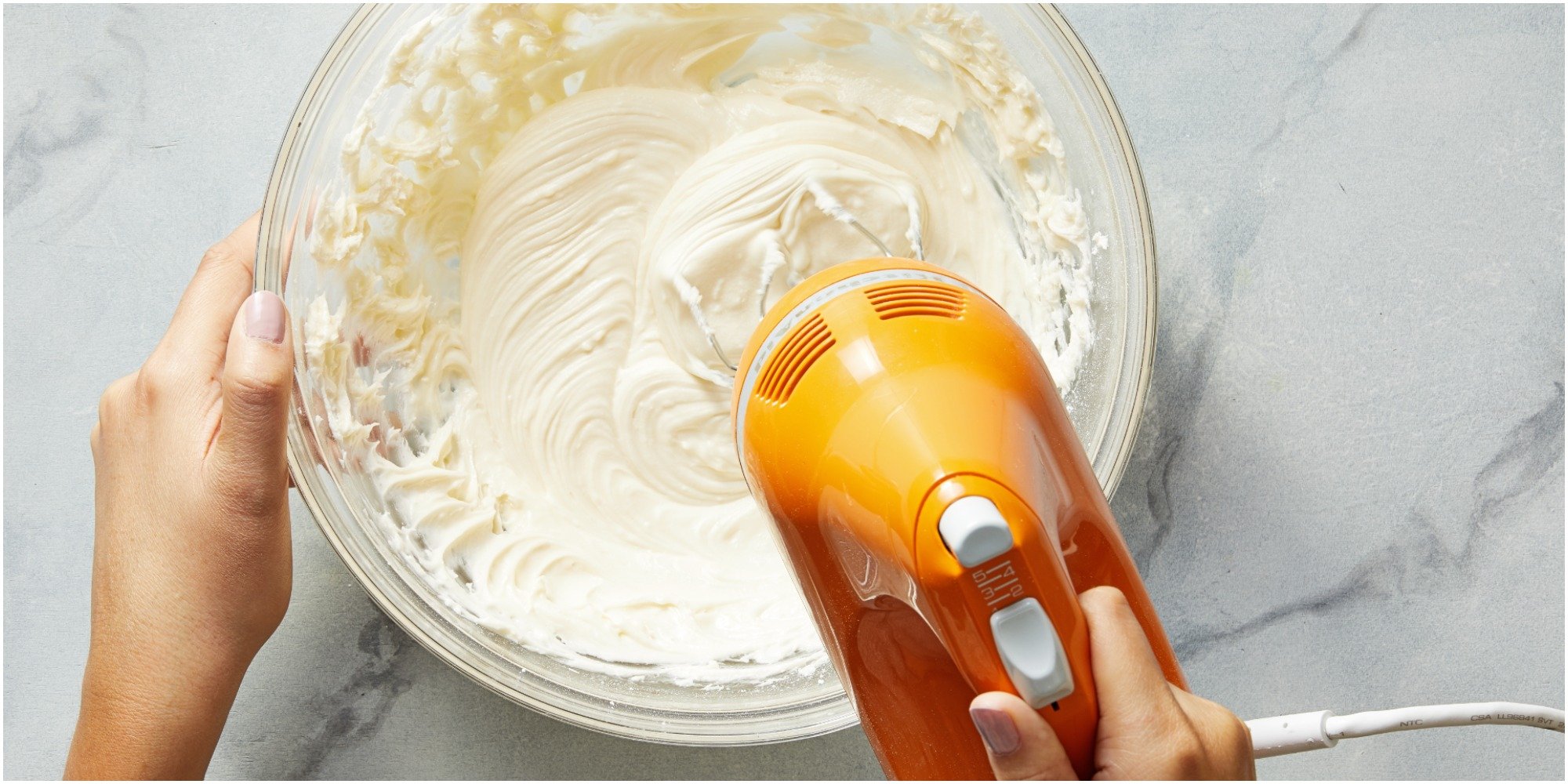 Buttercream icing mixed with a hand mixer.