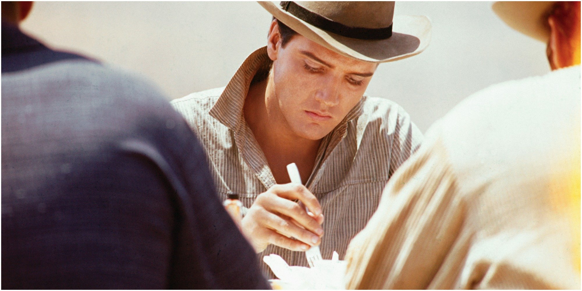 Elvis Presley eating on the set.