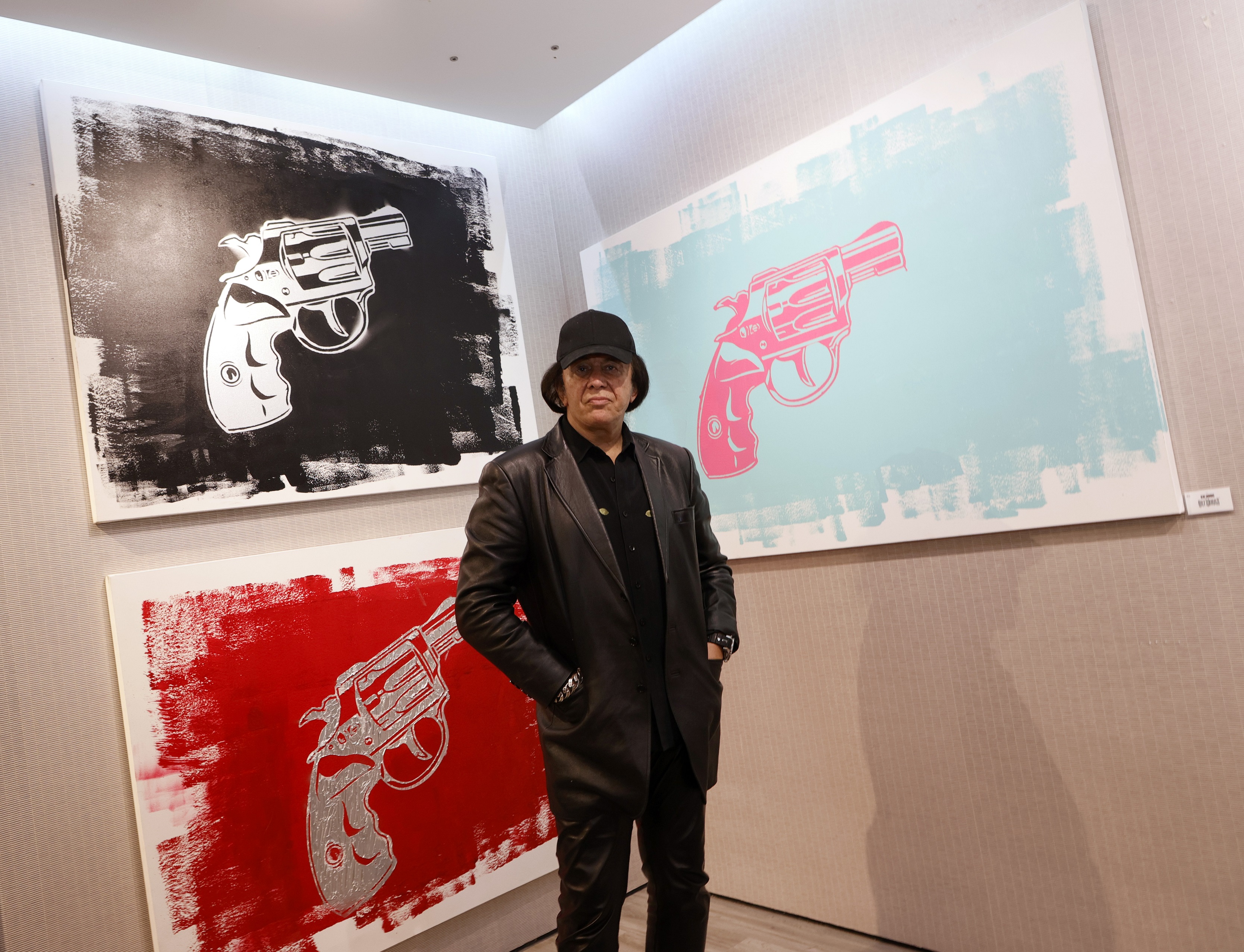 Gene Simmons with paintings of revolvers