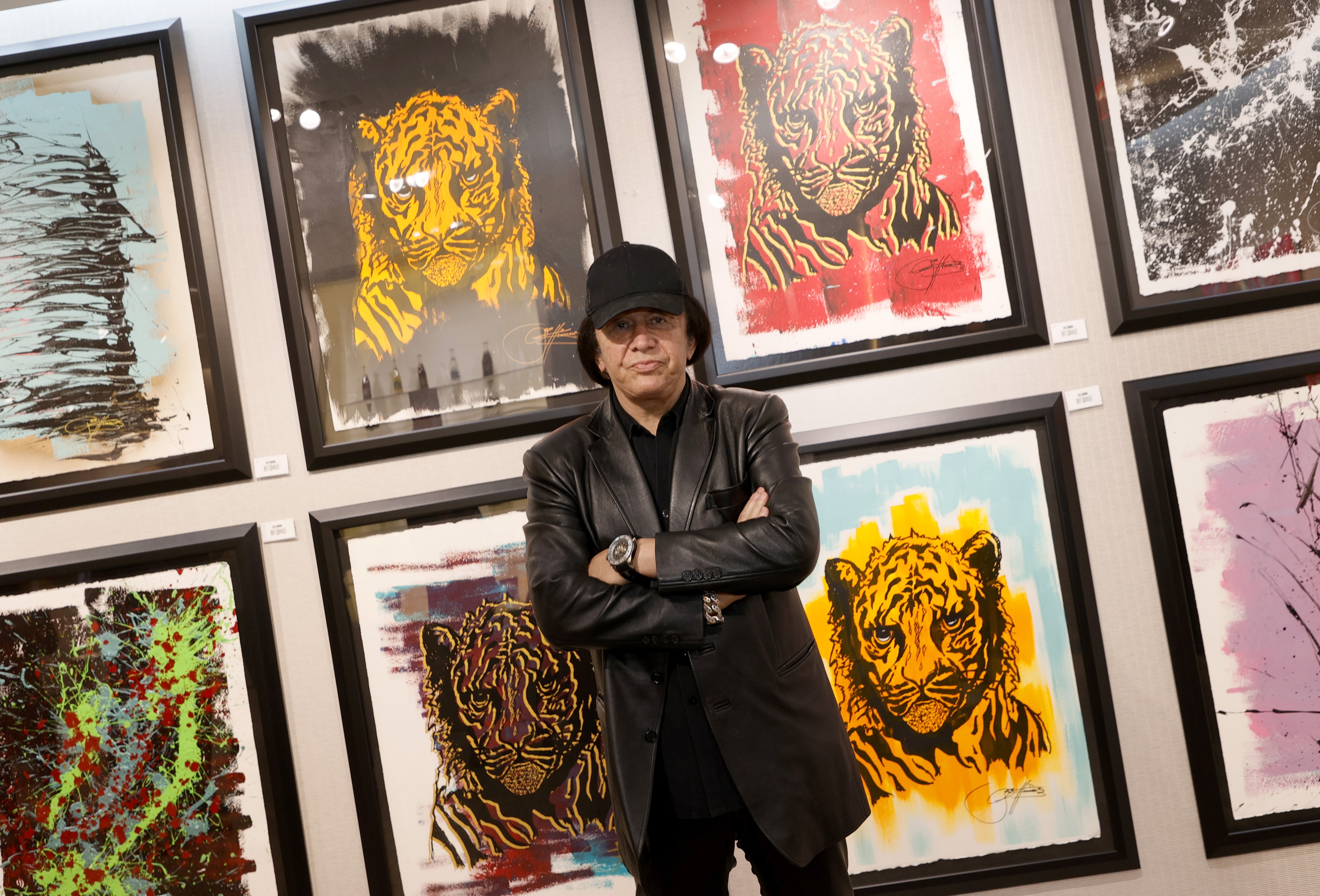 Gene Simmons with paintings of tigers