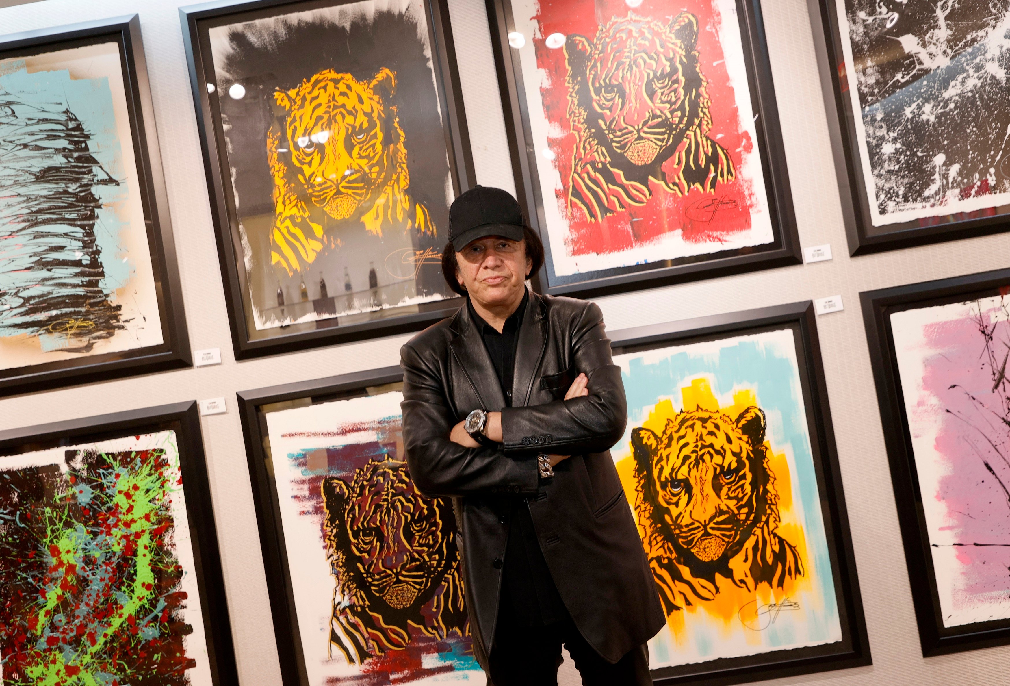 Gene Simmons with paintings of tigers