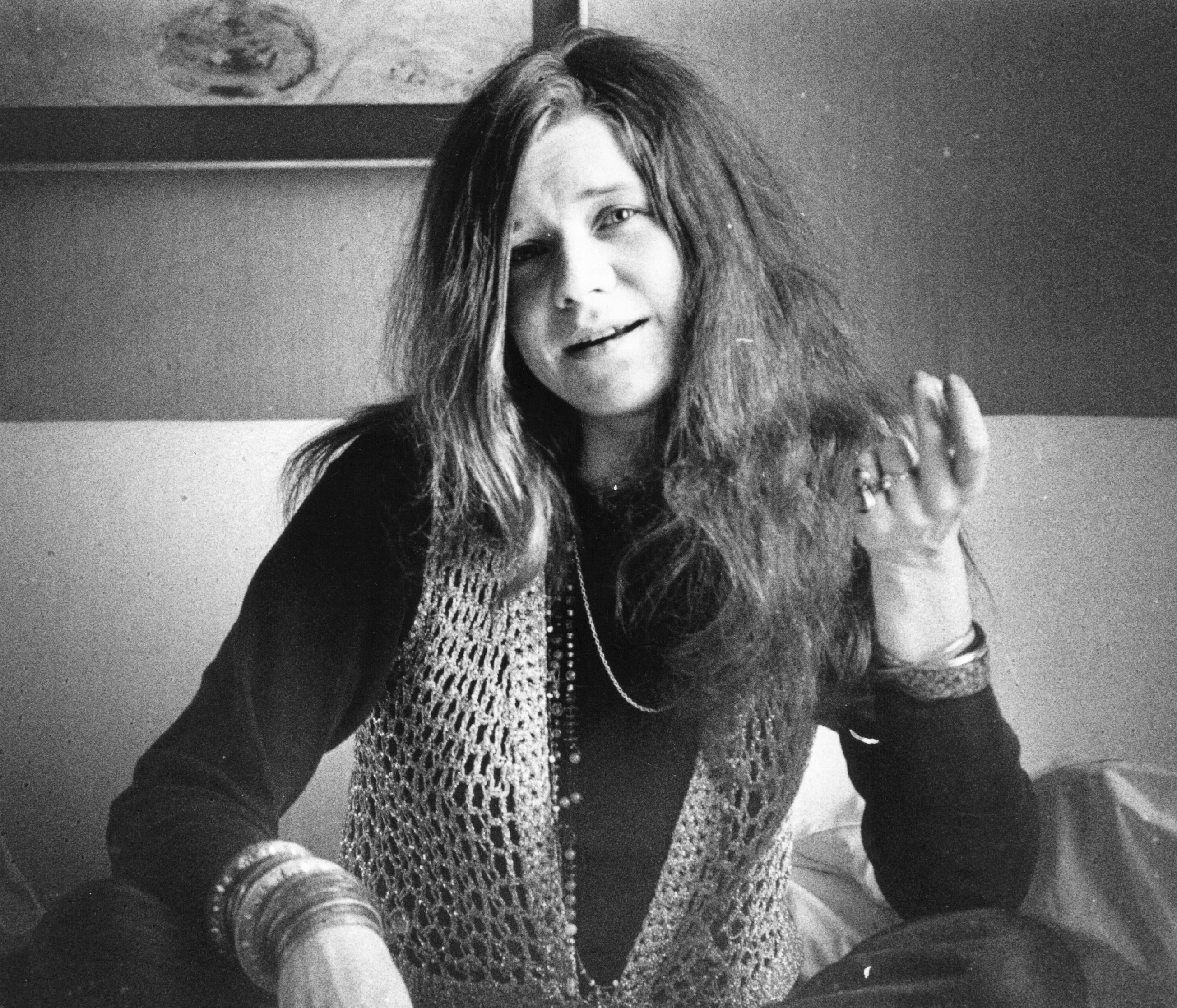 Janis Joplin sitting on a couch