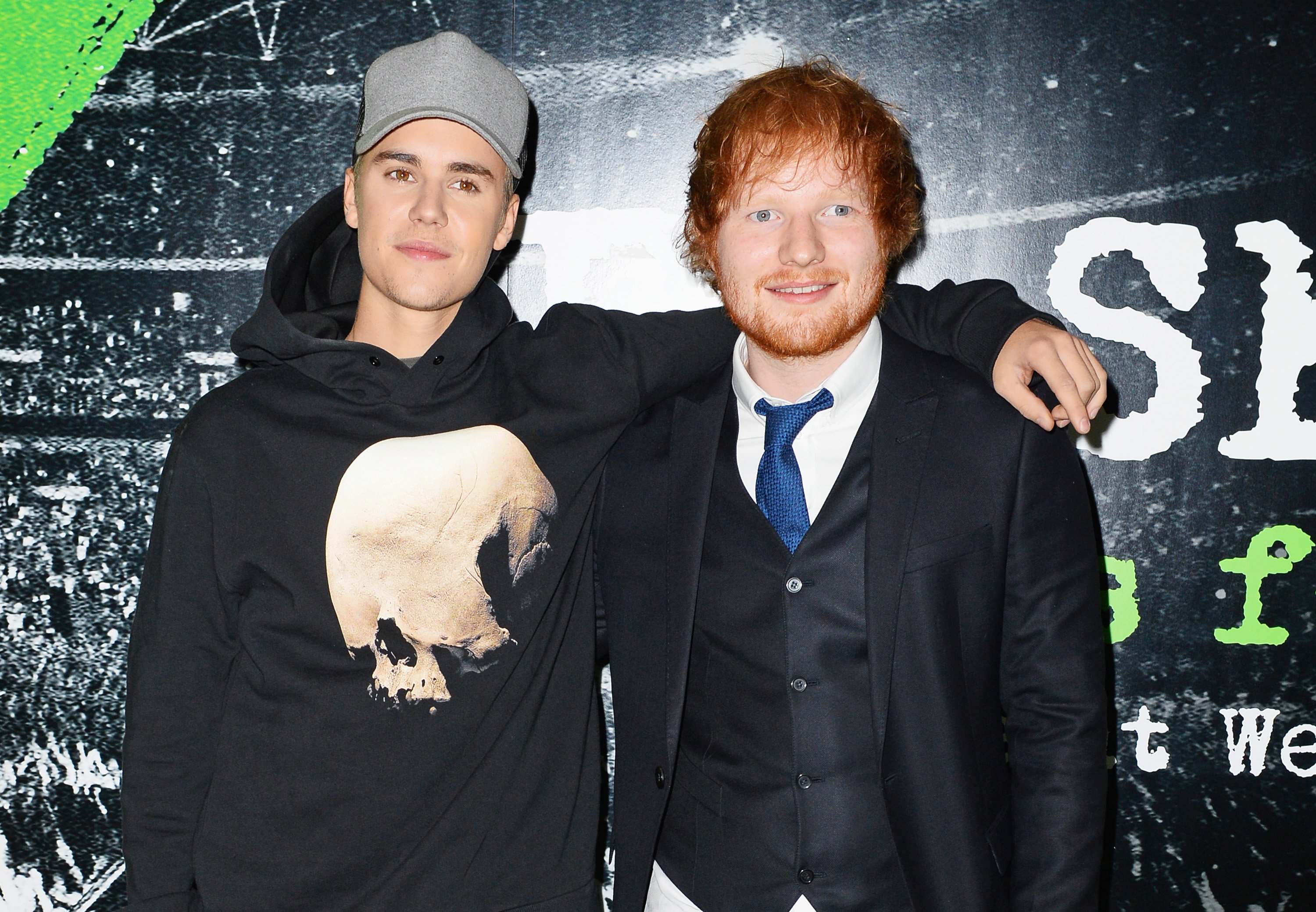 Justin Bieber and Ed Sheeran with a black background