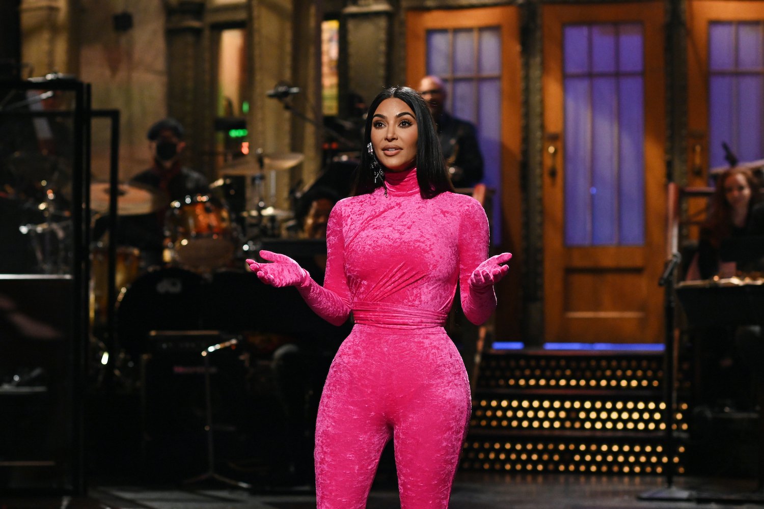 Kim Kardashian West wears hot pink top, pants, and matching gloves during an October 2021 'Saturday Night Live' monologue