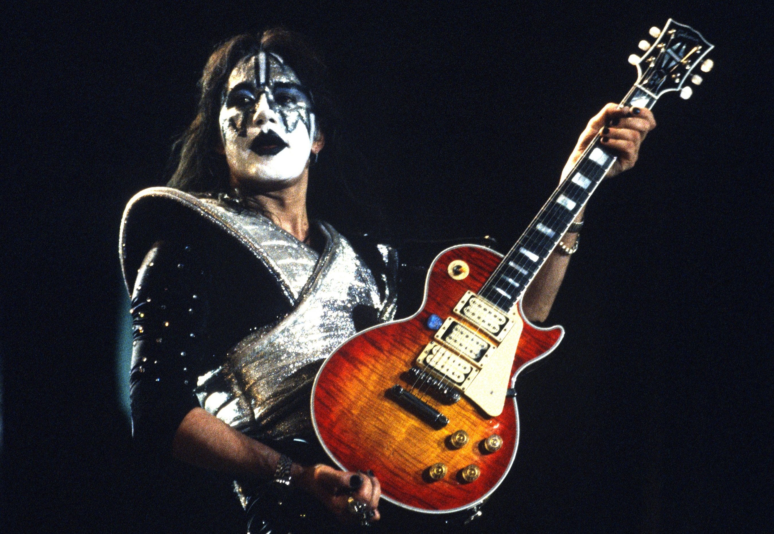 Kiss' Ace Frehley with a guitar