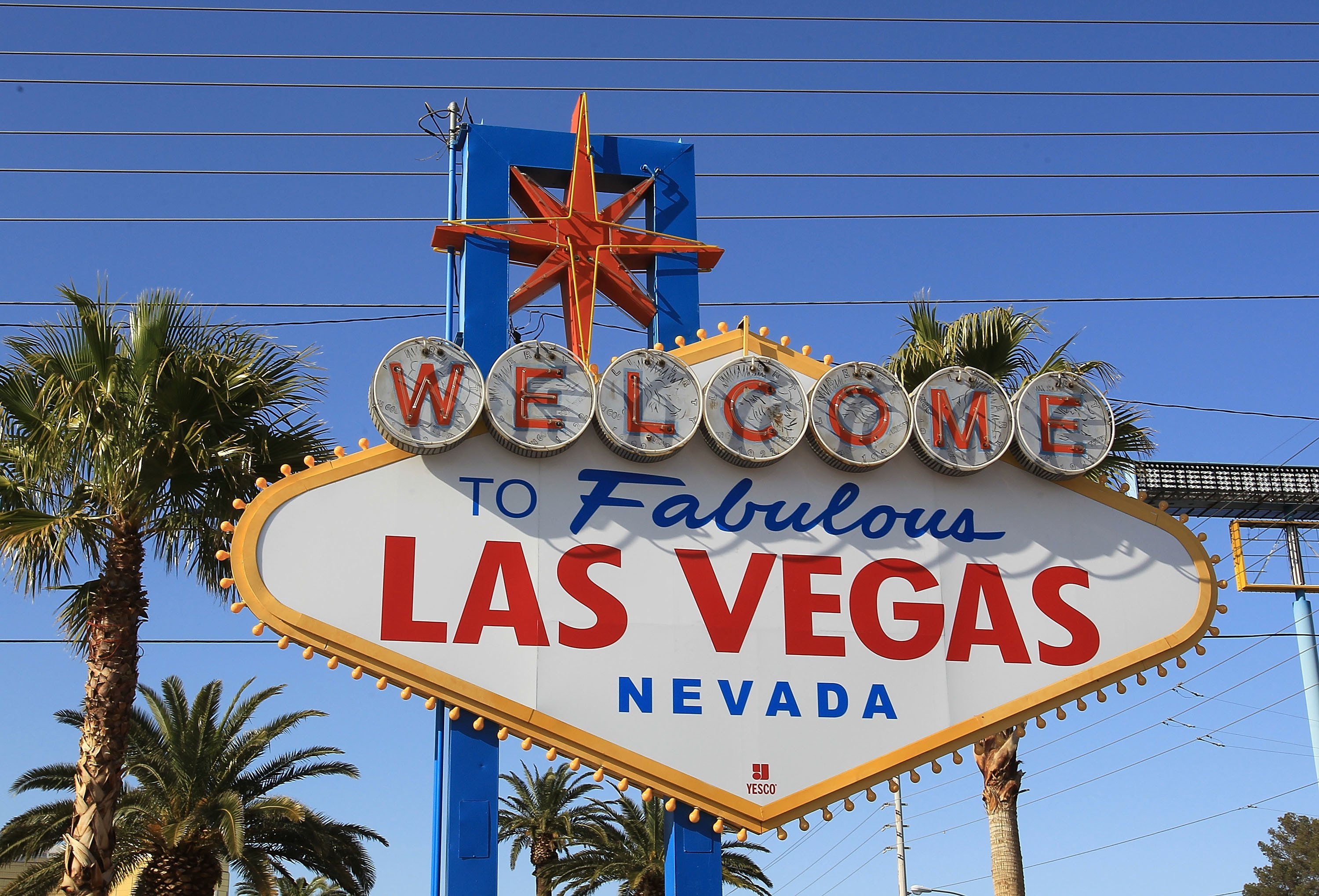 The Las Vegas sign near palm trees