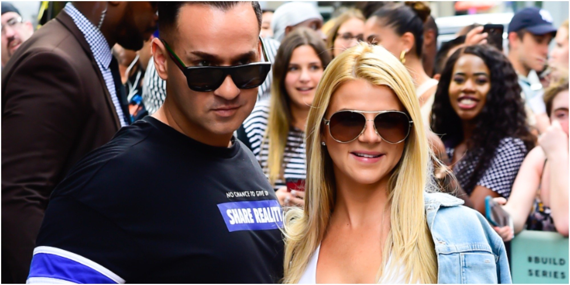 Lauren and Mike Sorrentino stop to take a photograph on a New York City street.