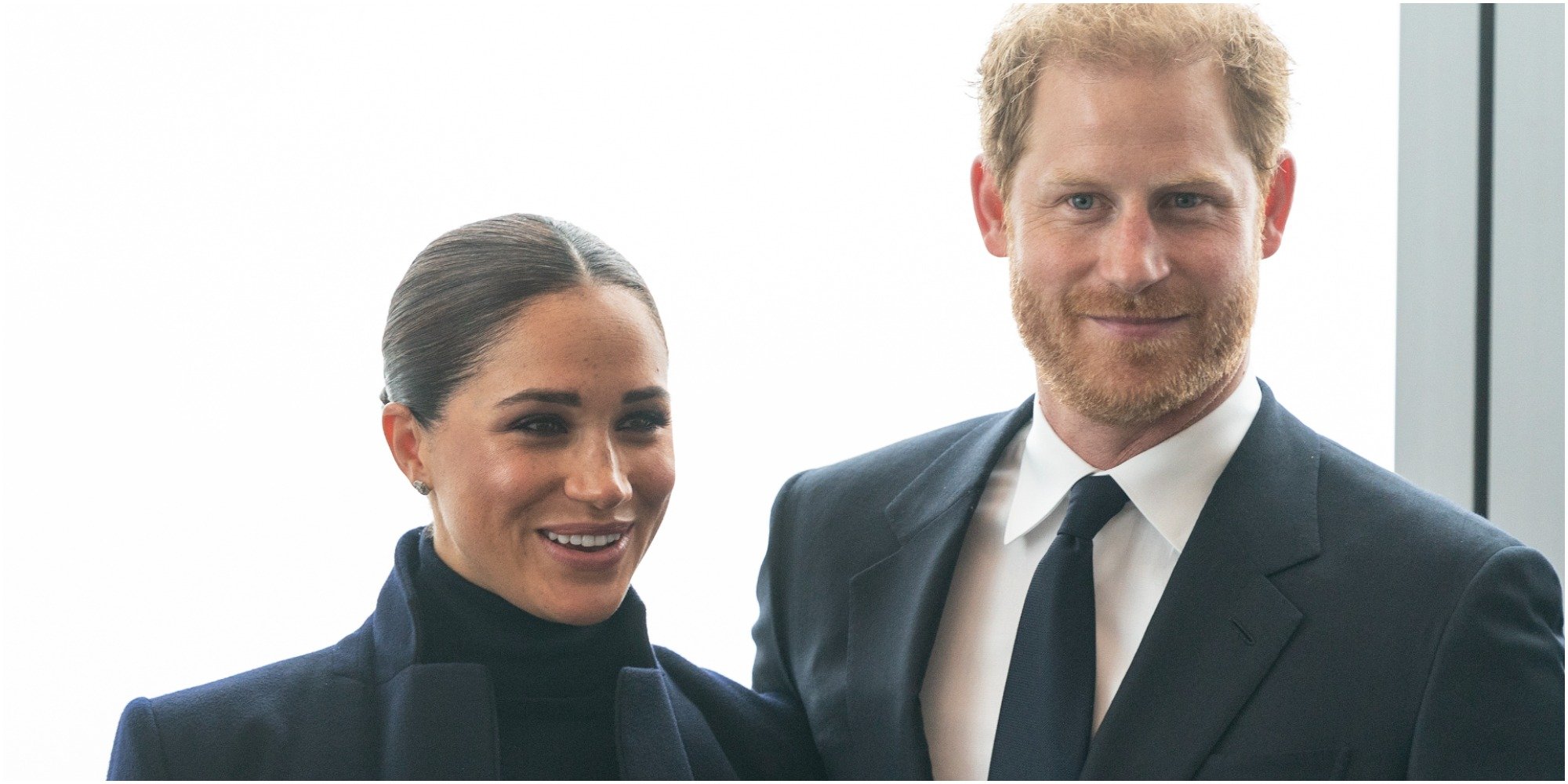 Meghan Markle and Prince Harry smile as they stand next to each other during a visit to One World Trade Center in New York City.