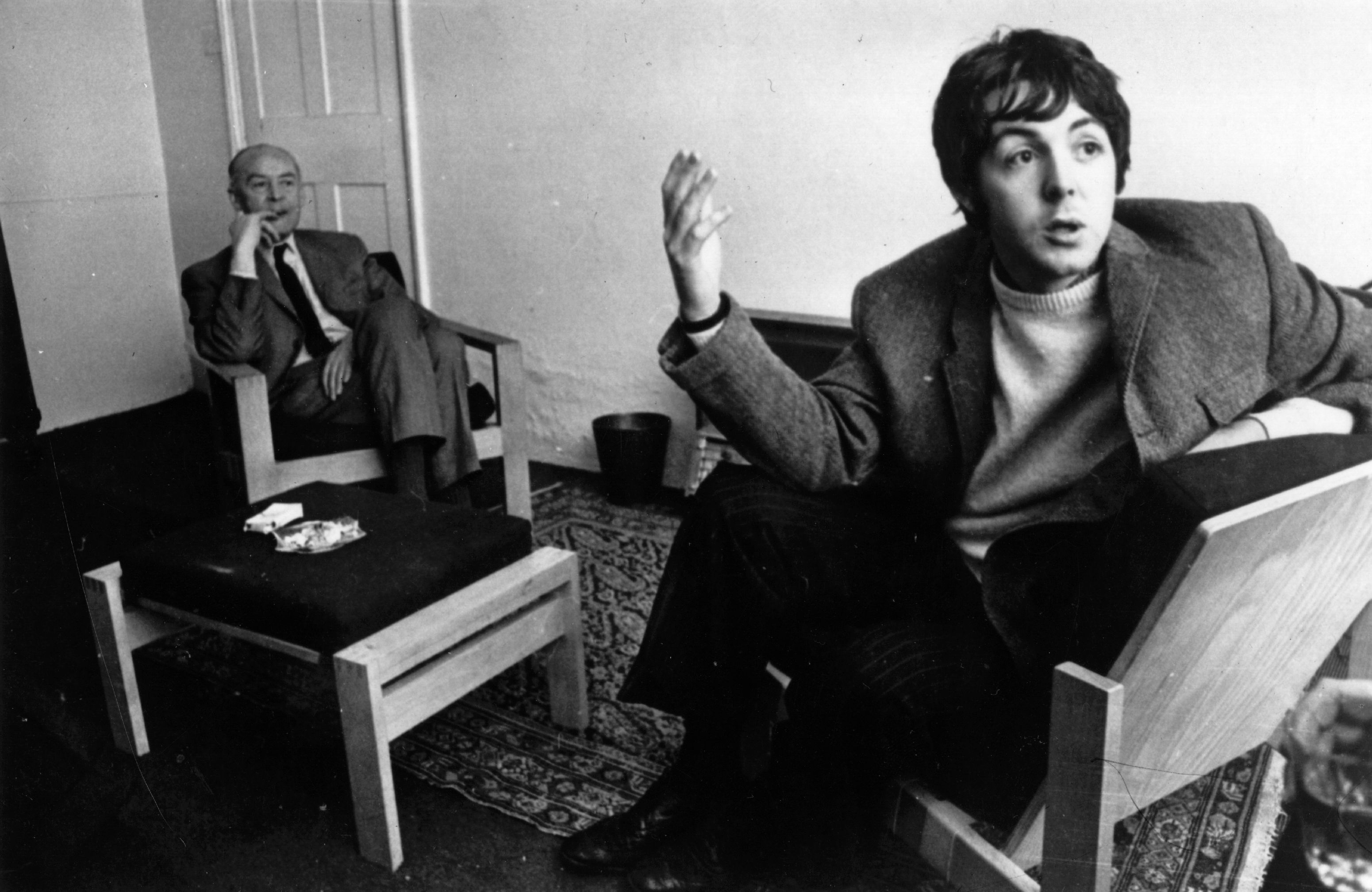 Paul McCartney and his father, James McCartney, sitting near a coffee table