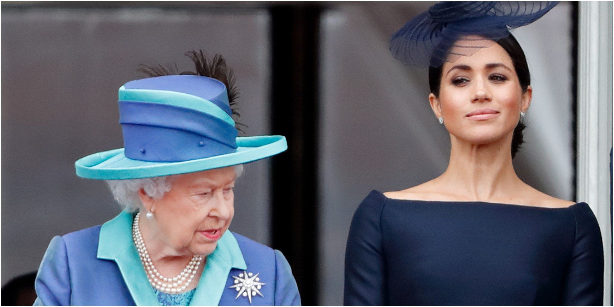 Queen Elizabeth and Meghan Markle watch a flypast to mark the centenary of the Royal Air Force from the balcony of Buckingham Palace on July 10, 2018.