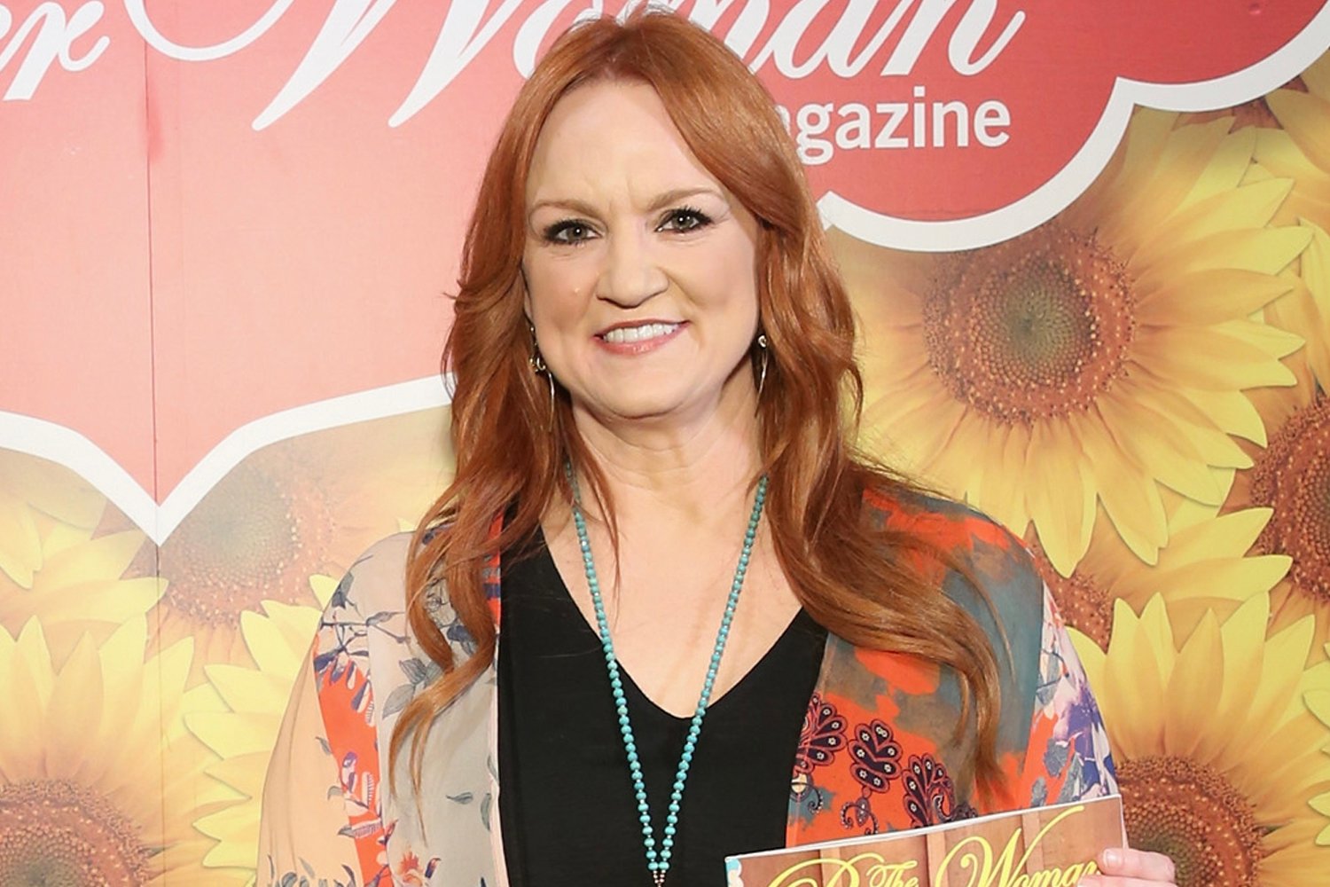 Ree Drummond smiles holding a copy of 'The Pioneer Woman' magazine