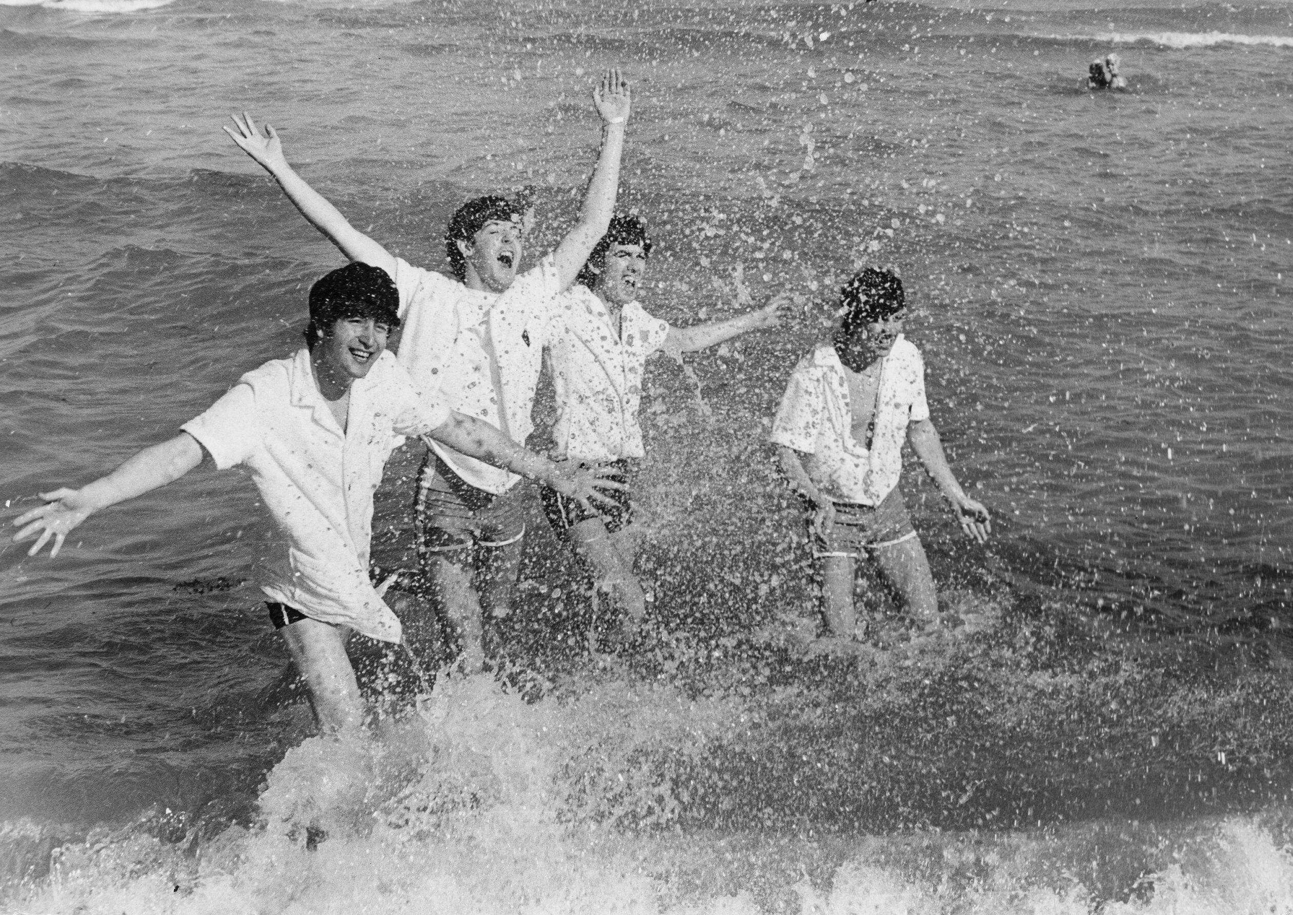 English pop group The Beatles frolicking in the surf at Miami Beach, Florida, February 1964. Left to right: John Lennon (1940 - 1980), Paul McCartney, George Harrison (1943 - 2001), Ringo Starr.