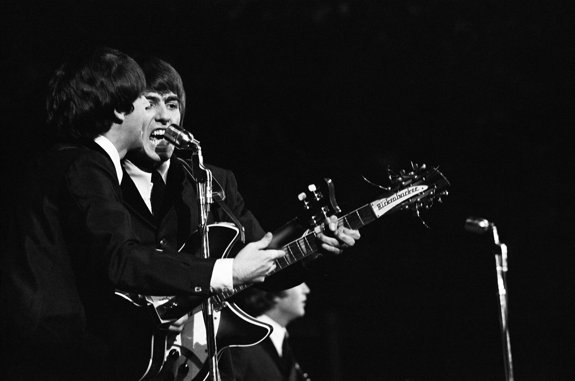 The Beatles August 19th 1964, more than six months after taking the East Coast by storm, the Fab Four traveled to California to take the stage at the Cow Palace in San Francisco for opening night of their first-ever concert tour of North US. (Picture) Paul McCartney (left) and George Harrison belting out one of the their many hits on stage.