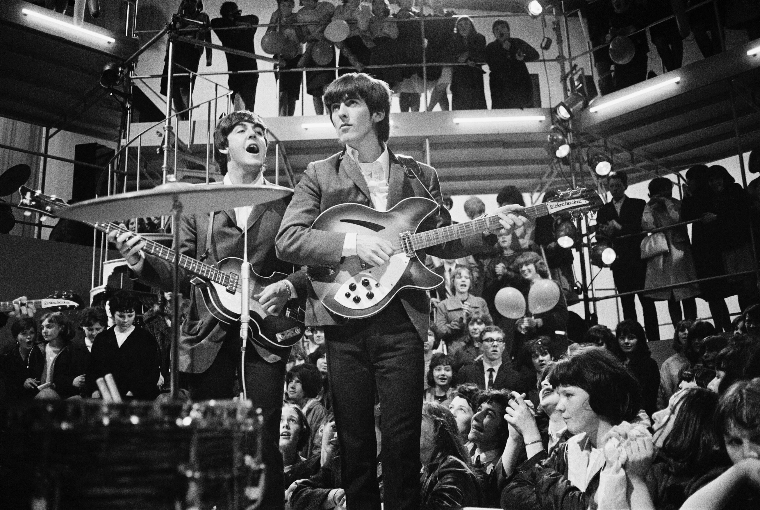 Paul McCartney and George Harrison of The Beatles, performing at a rehearsal for the 'Round The Beatles' TV show at the Rediffusion TV studios in Wembley, London, April 127, 1964.