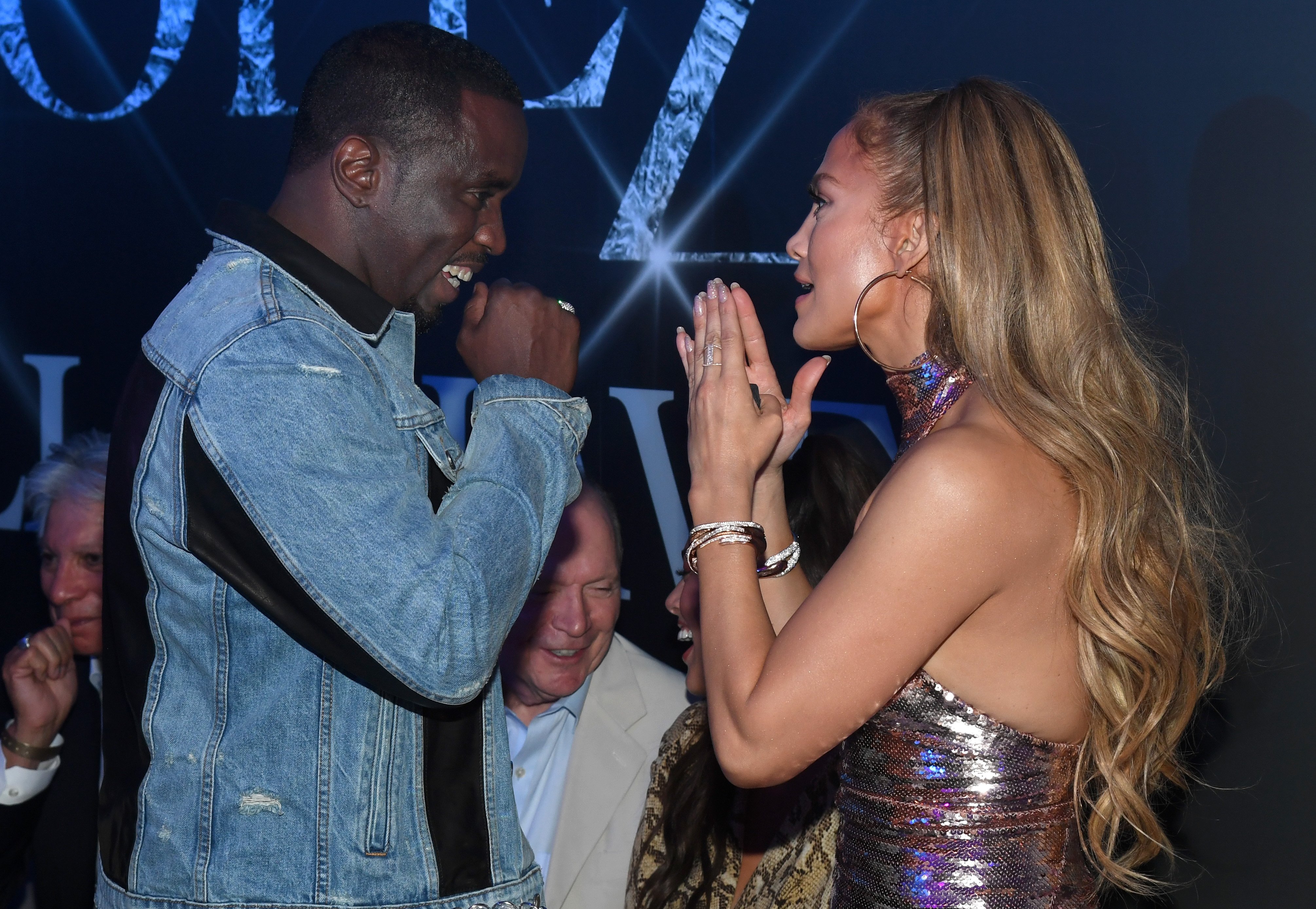 Sean 'Diddy' Combs and Jennifer Lopez have a conversation during a party