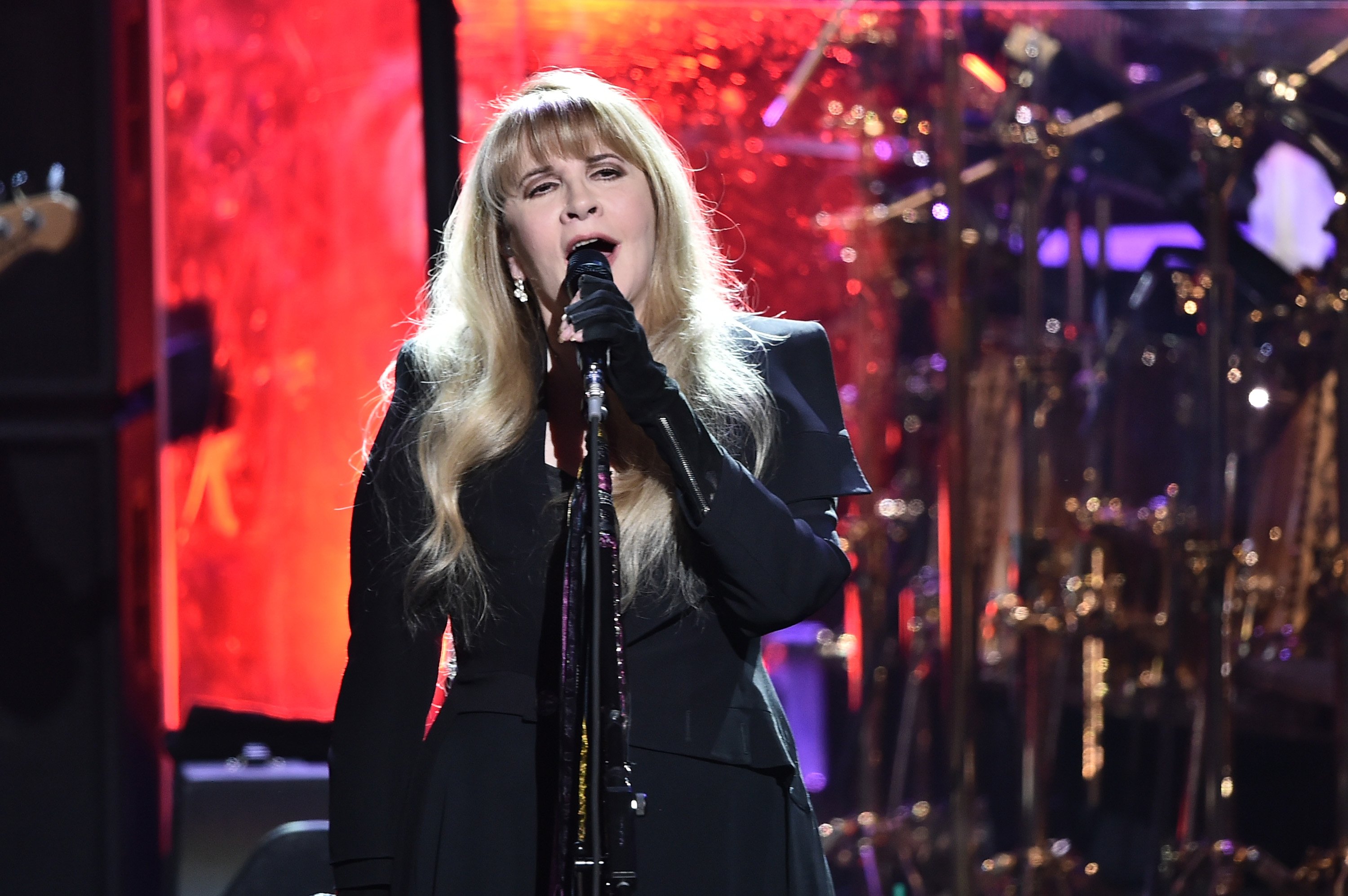 Stevie Nicks wears a black outfit while performing.