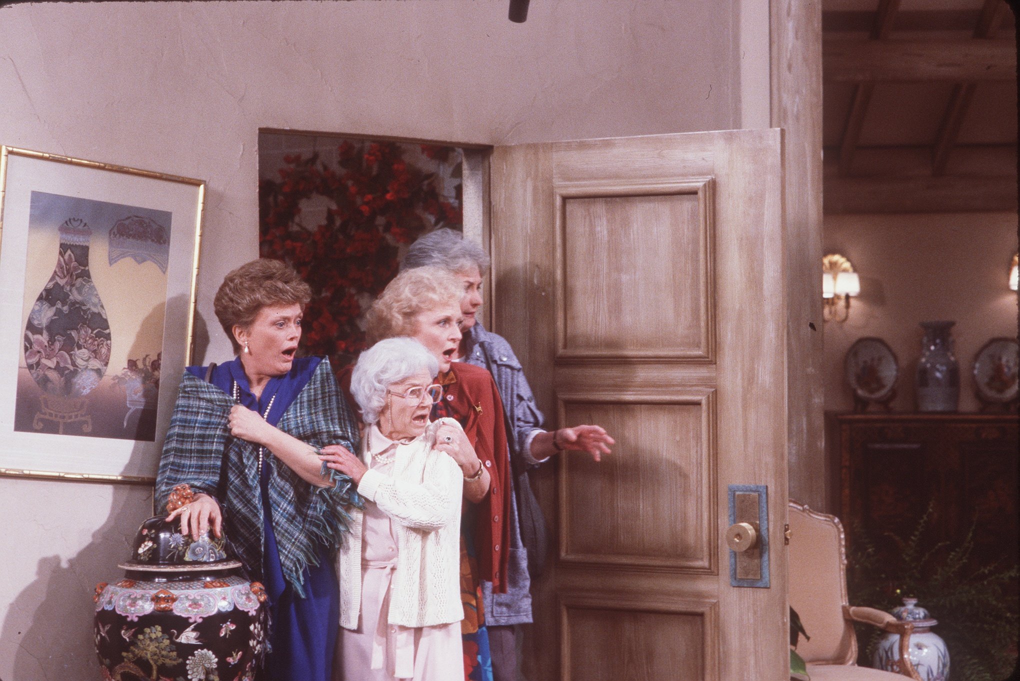 The cast of 'The Golden Girls' stand at the front door on the show's set
