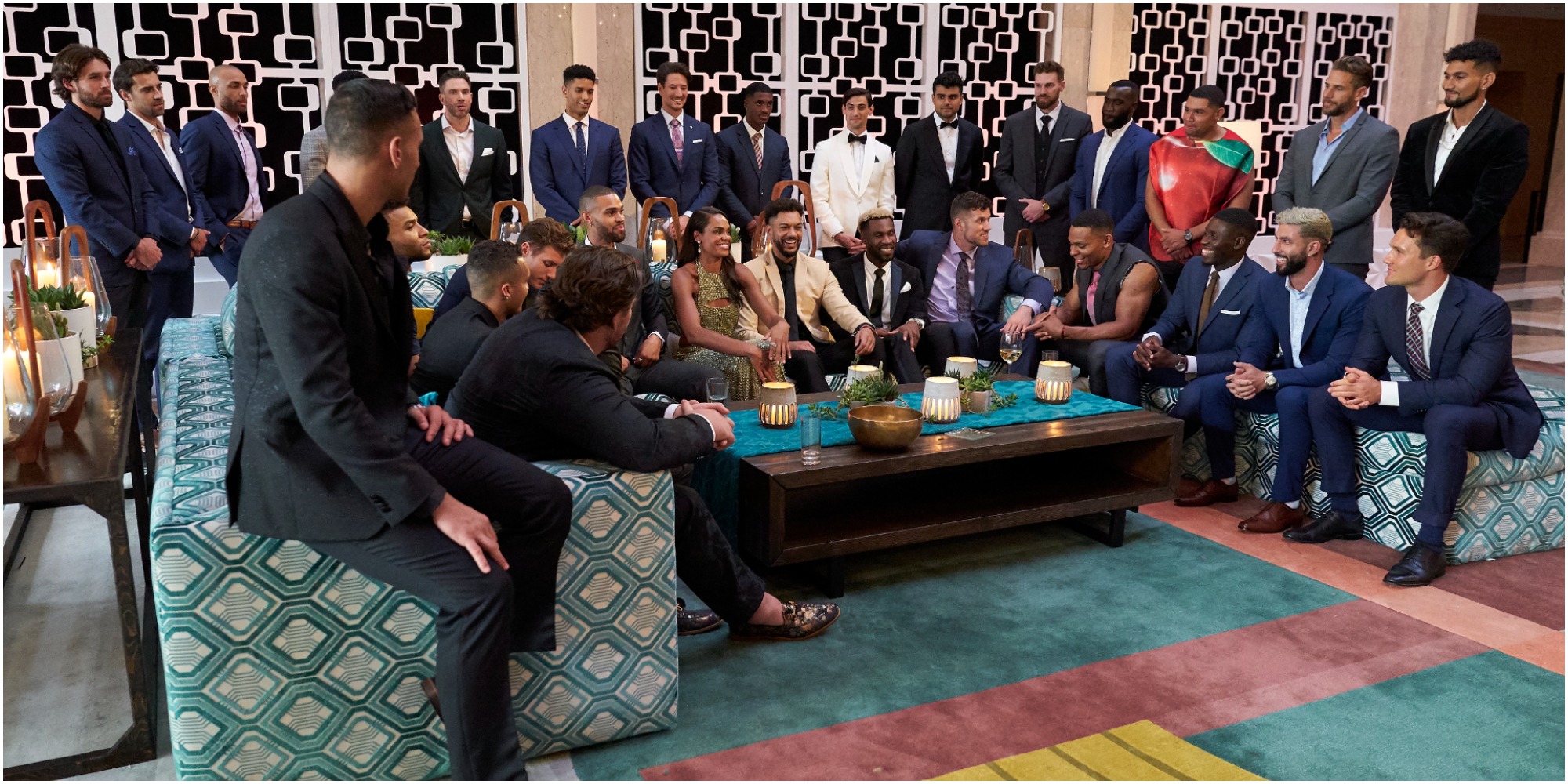 The cast of "The Bachelorette" is seated on the set of the ABC dating show.