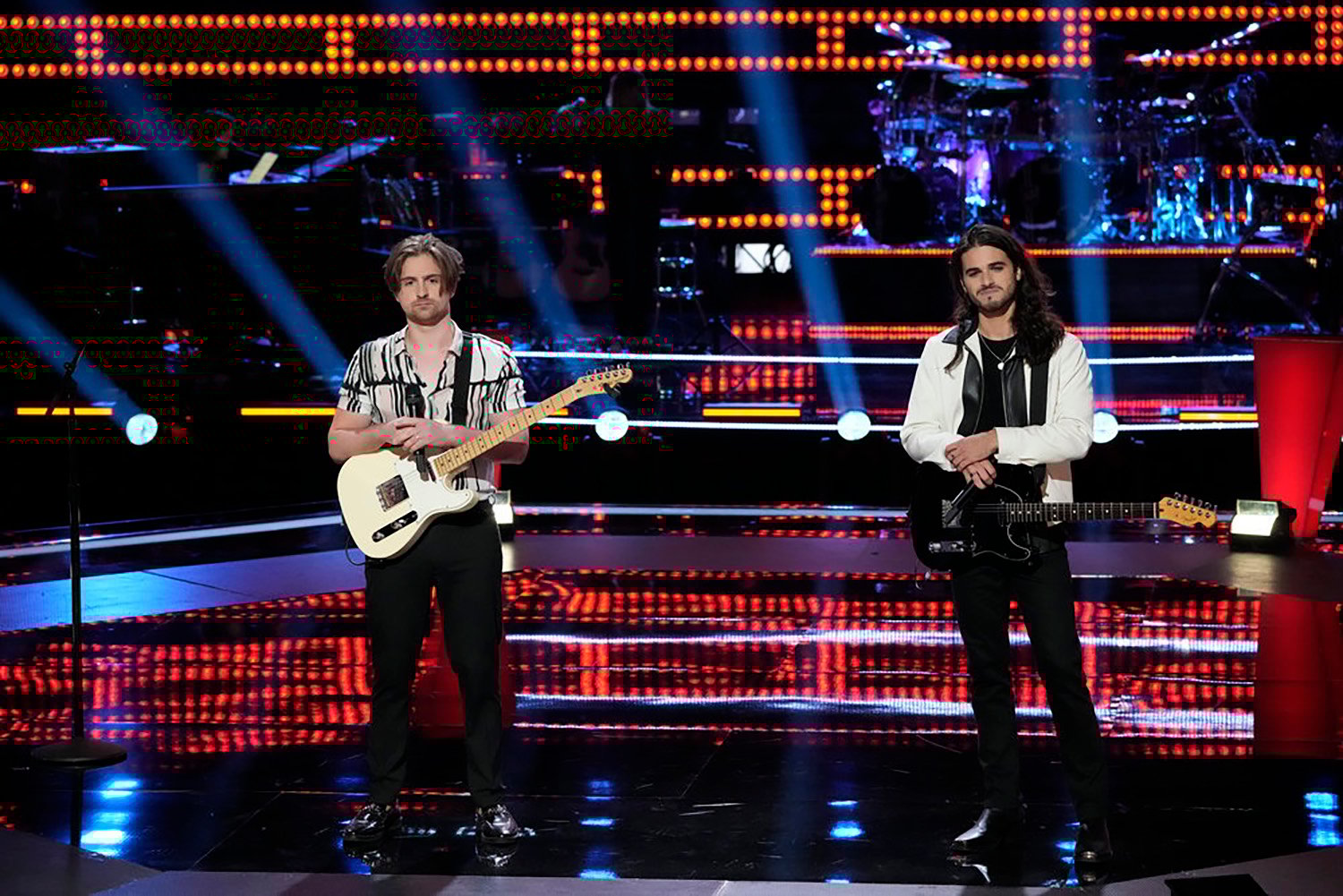 Chavon Rogers and David Vogel stand on stage after performing on The Voice Season 21 Episode 7, the Battles Premiere.