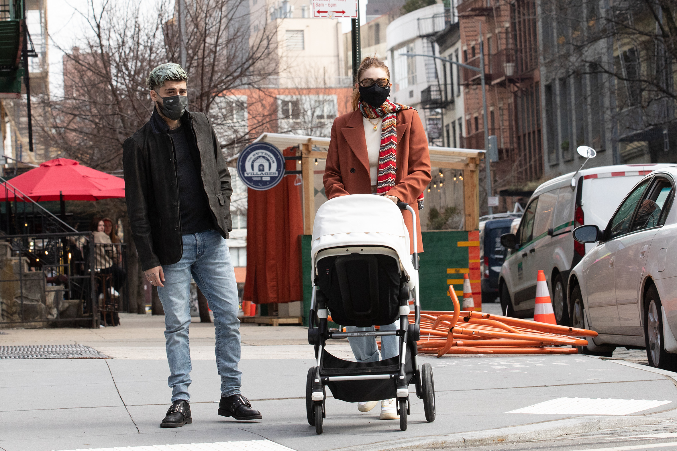 Zayn Malik and Gigi Hadid pushing a stroller with their baby