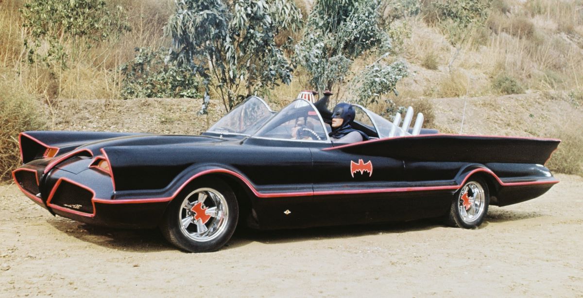 Adam West as Bruce Wayne/Batman at the wheel of the Batmobile with passenger Burt Ward as Dick Grayson/Robin in the TV series 'Batman', circa 1966.