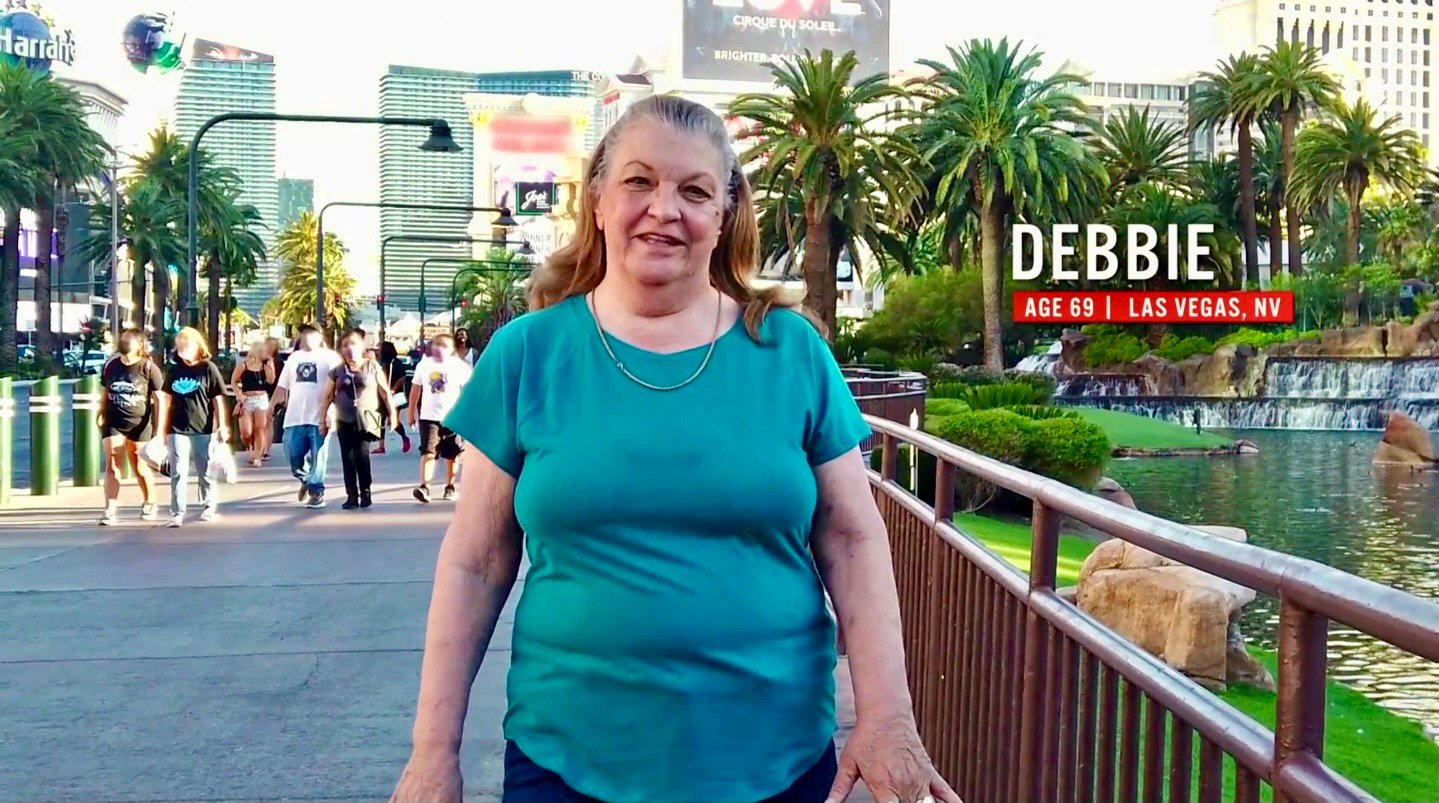 '90 Day Fiancé' star Debbie Johnson in a blue shirt walking down the Las Vegas strip in a still from '90 Day: The Single Life.'