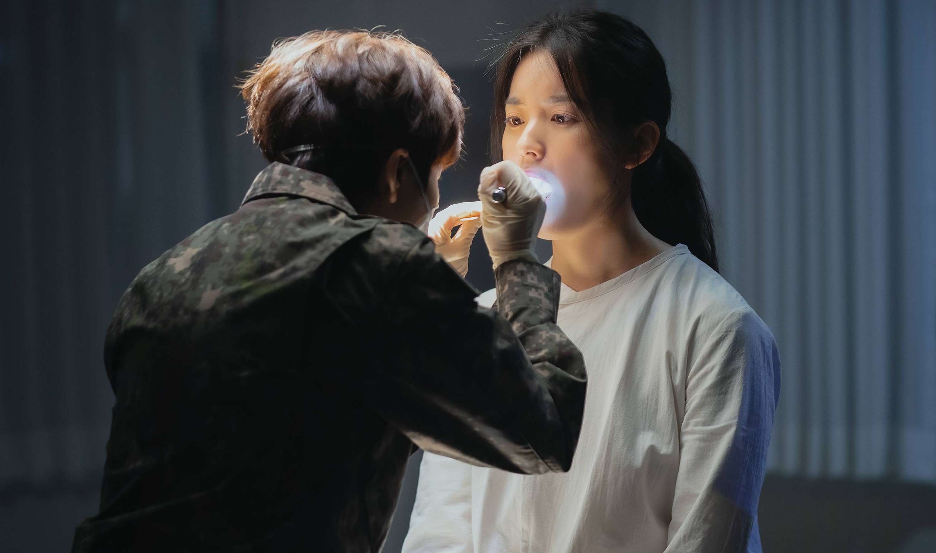 Actor Han Hyo-joo as Yoon Sae-bom for 'Happiness' episode 1 being inspected by female officer.