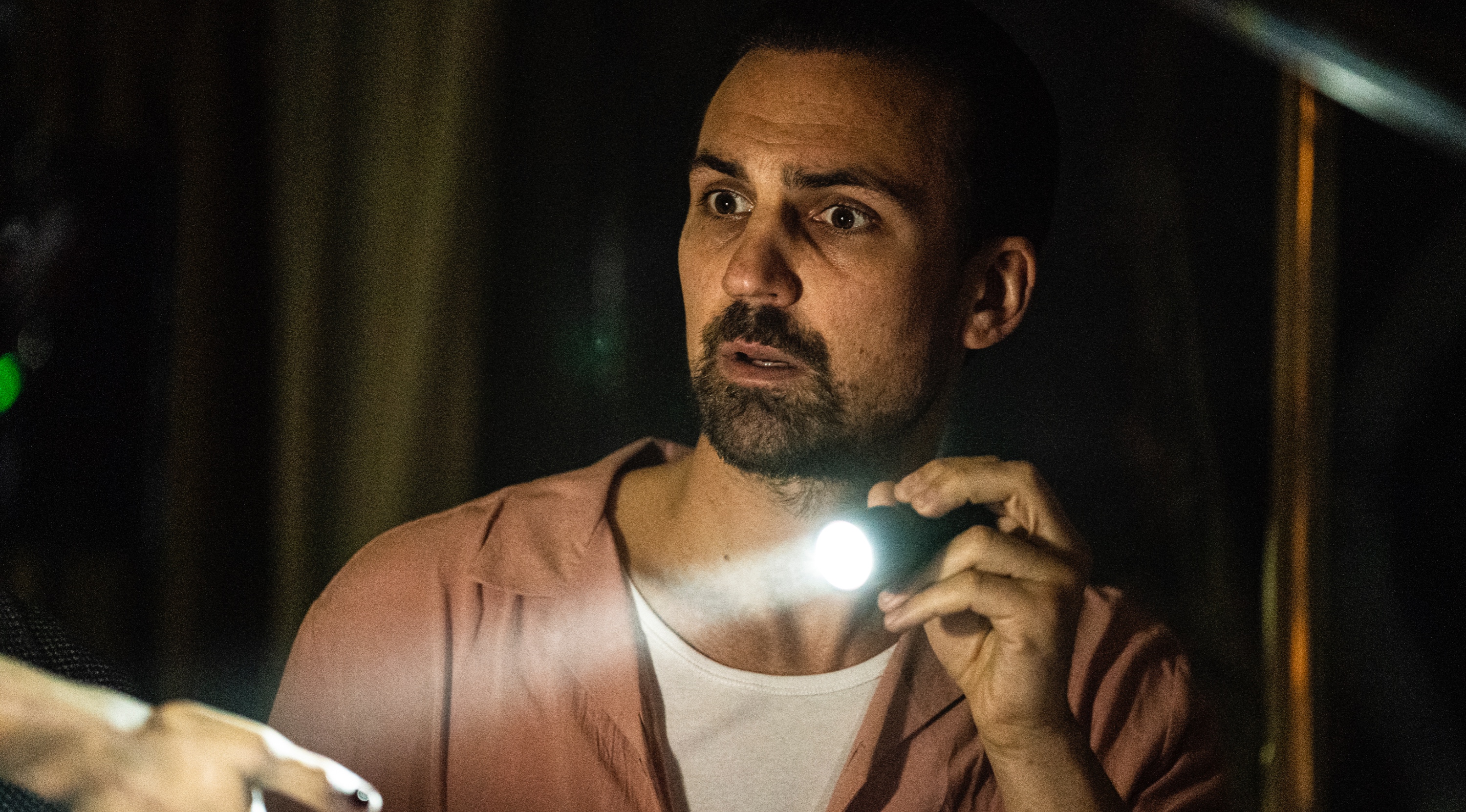 Actor Henry Llyod Hughes as Nathan Rose for 'Ragdoll' episode 1 holding a flashlight