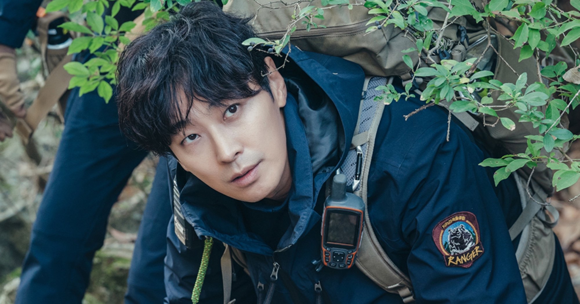 Actor Ju Ji-hoon as Kang Hyun-jo for subtitle 'Jirisan' K-drama wearing hiking gear.