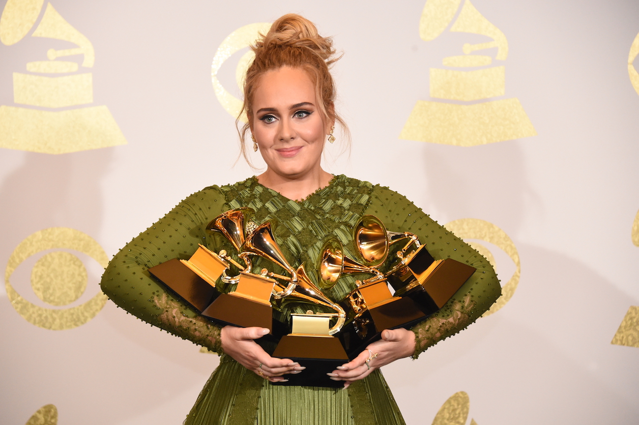 Adele holding all of her Grammys at the 2017 Grammy Awards. 