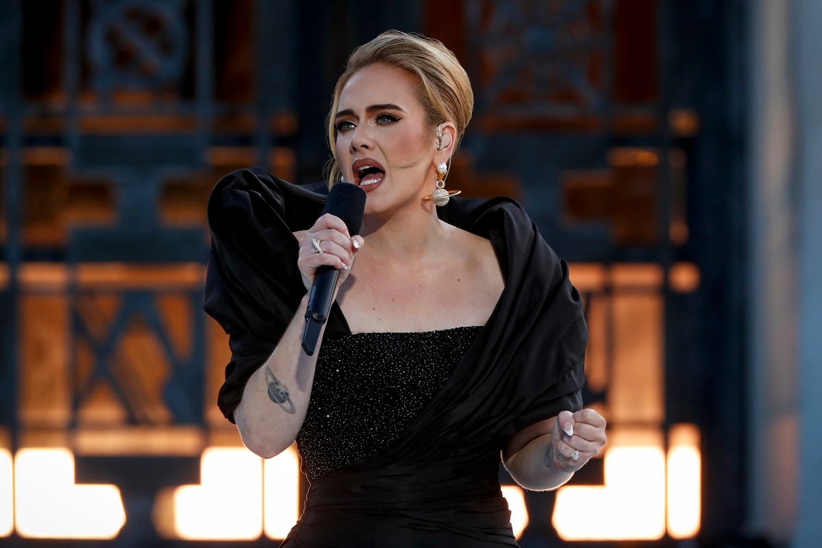 Adele singing into a microphone