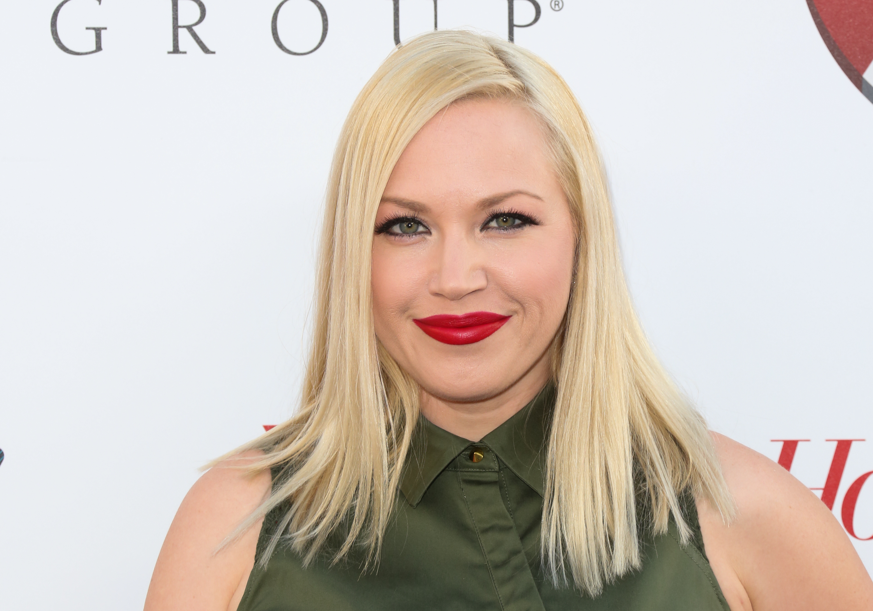 'The Bold and the Beautiful' actor Adrienne Frantz wearing a green dress and red lipstick.