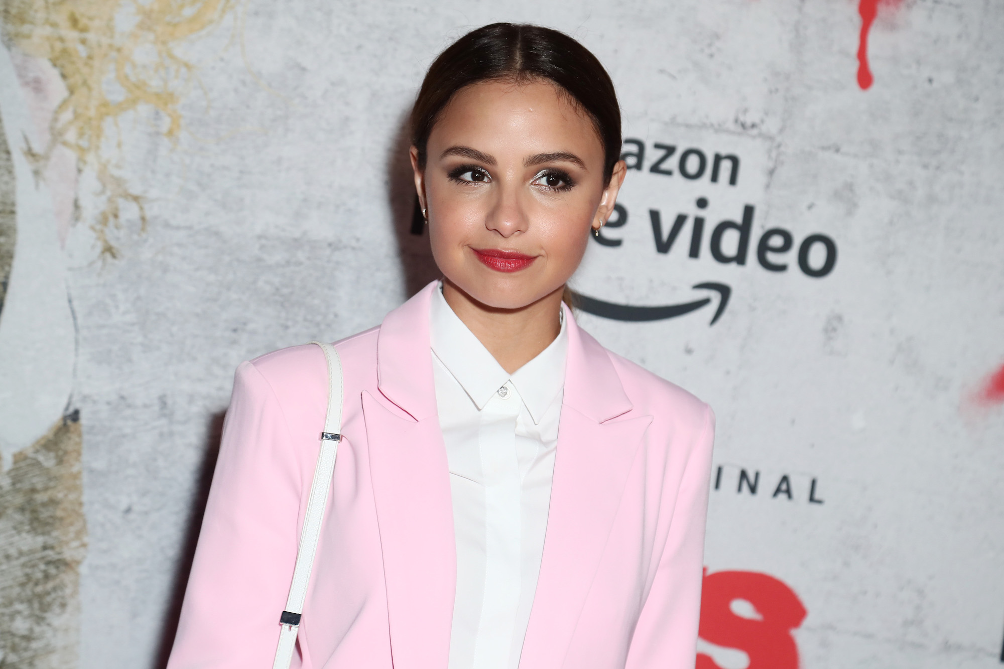 Aimee Carrero wearing a pink blazer and white shirt to 2019 Comic-Con International.