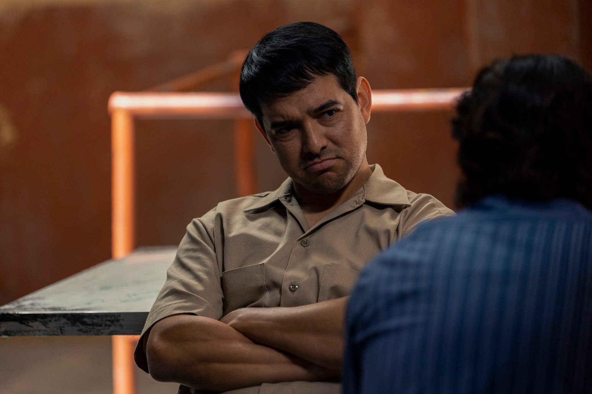 Alejandro Edda wearing a tan colored shirt and pant in 'Narcos: Mexico' Season 3