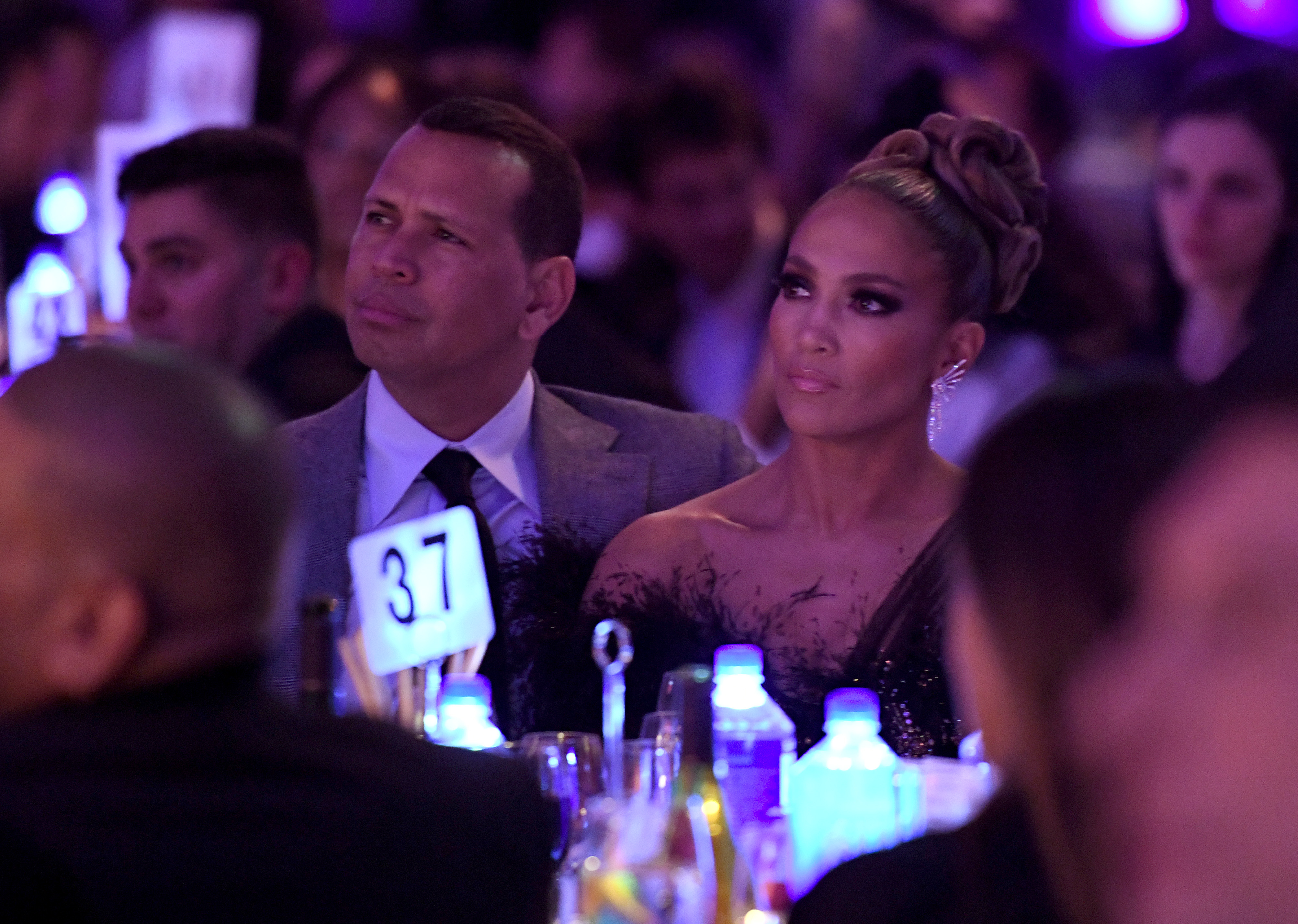 Alex Rodriguez and Jennifer Lopez sit together during dinner. 