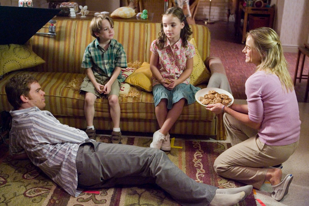 Astor and Cody sit on the couch with Dexter and Rita on the floor in a scene from 'Dexter.'